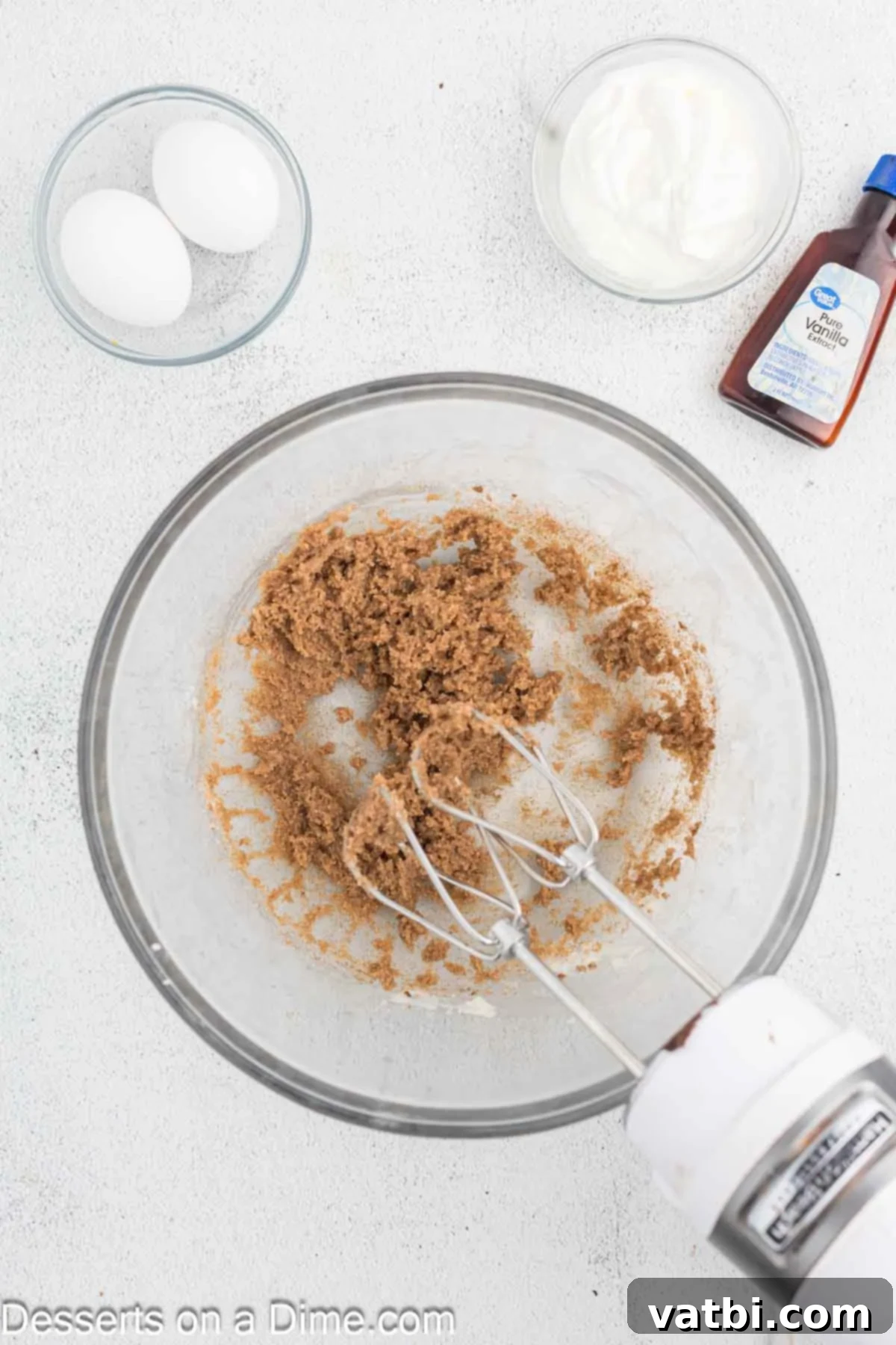 Decadent Churro Cake 5 Ground cinnamon being gently mixed into the creamed butter and sugar mixture on a low speed, ensuring even distribution of spice.