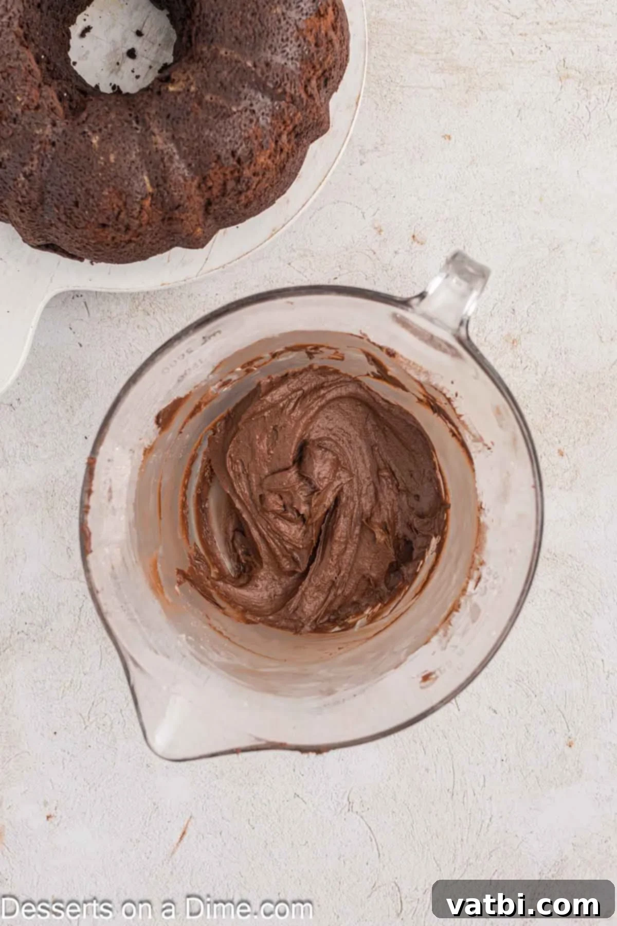 Decadent Chocolate Pound Cake 9 A bowl filled with powdered sugar, Dutch-process cocoa, melted butter, and heavy cream, ready to be blended into a rich chocolate frosting.