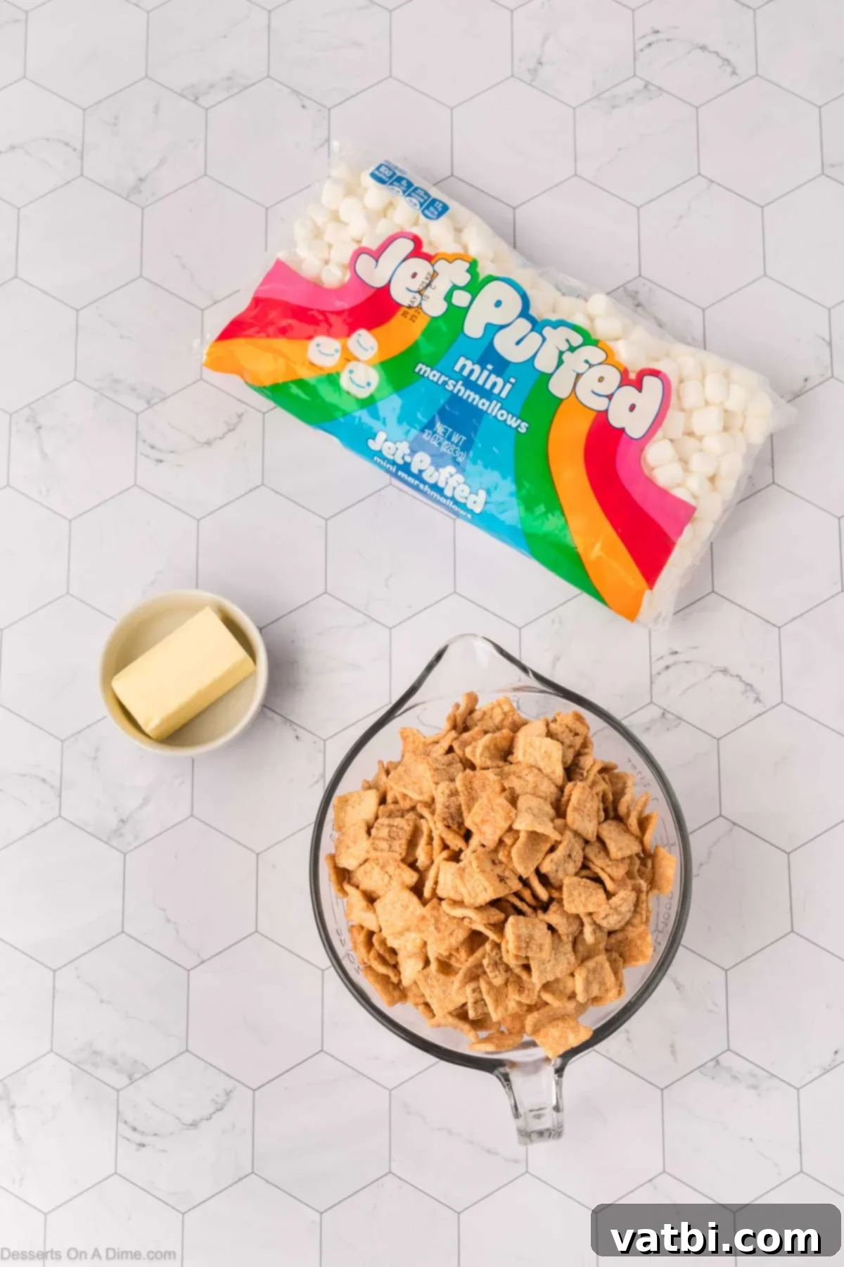 Irresistible Cinnamon Toast Crunch Bars 3 A visual of the three main ingredients for Cinnamon Toast Crunch Bars: Cinnamon Toast Crunch cereal, salted butter, and mini marshmallows.