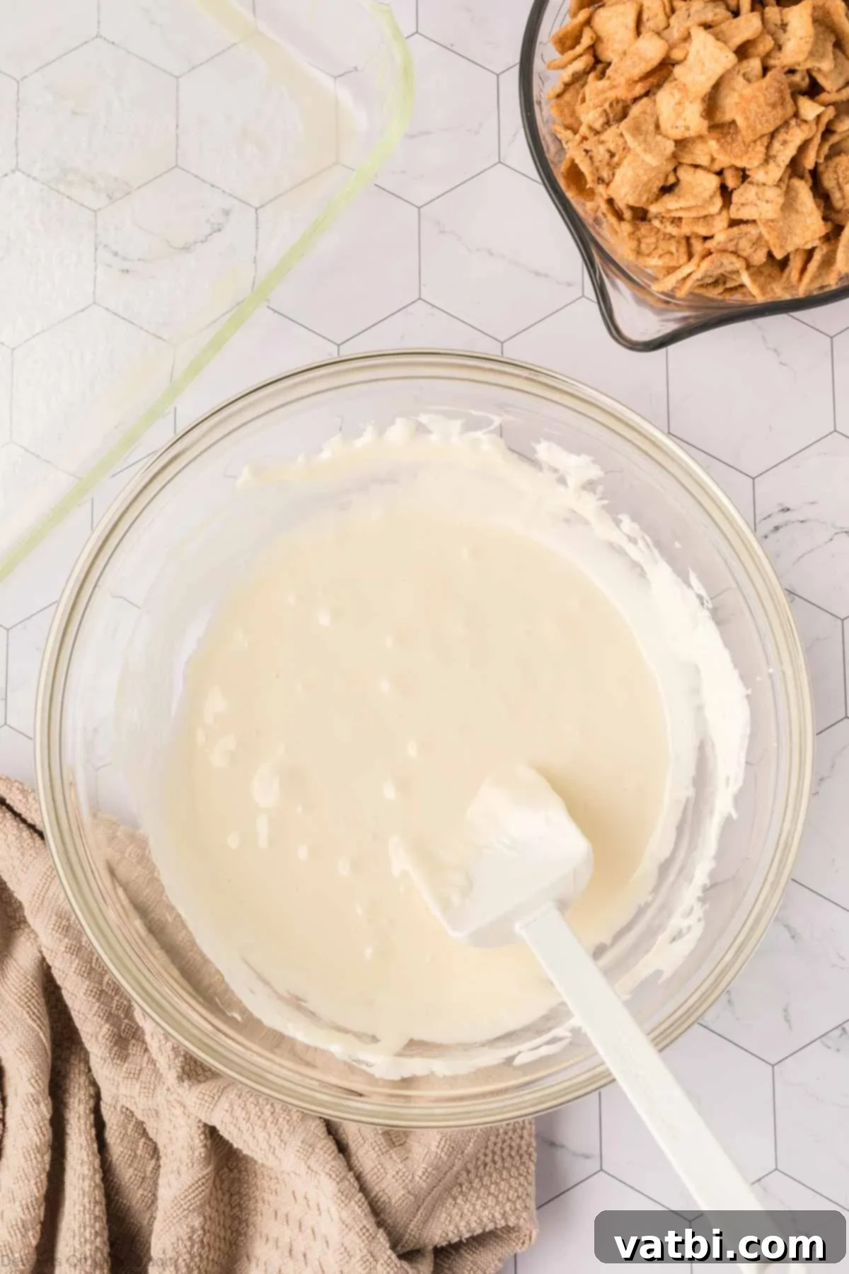 Irresistible Cinnamon Toast Crunch Bars 6 Smooth, melted marshmallow and butter mixture in a bowl.