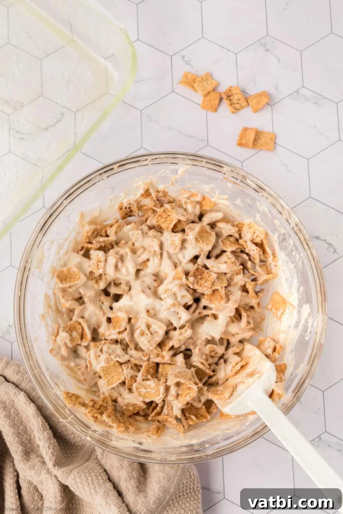 Irresistible Cinnamon Toast Crunch Bars 8 Fully combined Cinnamon Toast Crunch and marshmallow mixture in a bowl, ready for the pan.
