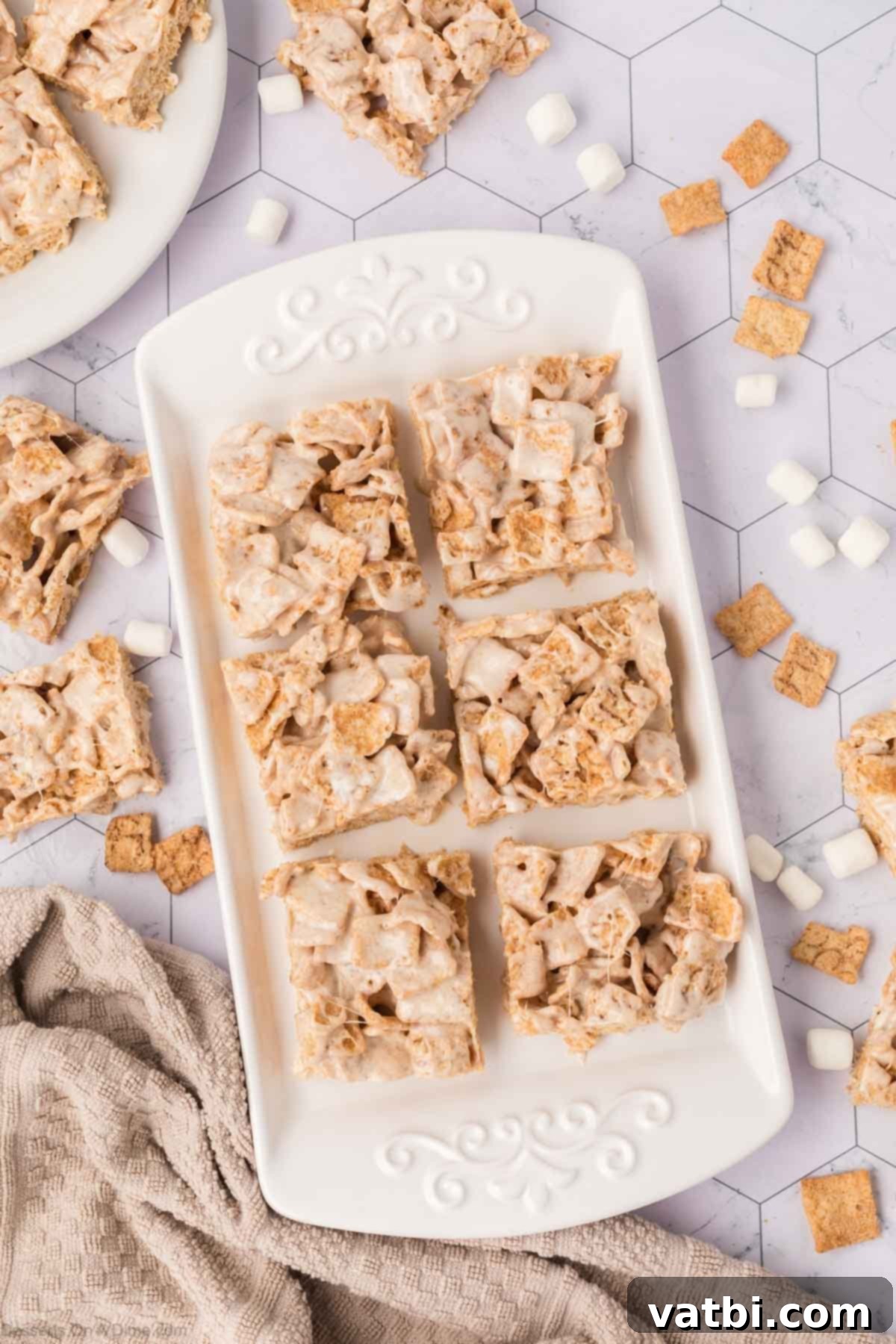 Irresistible Cinnamon Toast Crunch Bars 9 Cinnamon Toast Crunch Cereal Bars neatly cut into squares in a pan.