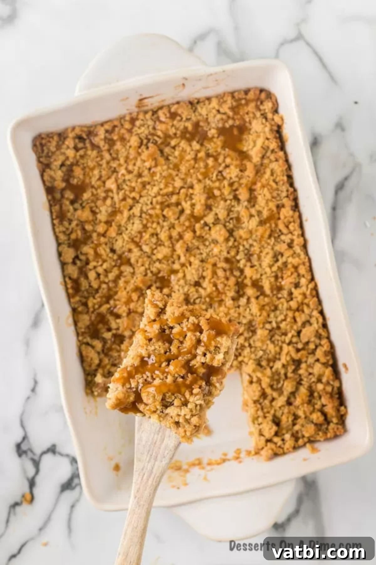 Harvest Caramel Apple Cheesecake Bars 15 Individual slices of Caramel Apple Cheesecake Bars arranged neatly, showing the distinct layers of crust, cheesecake, apples, and streusel, ready to be served and enjoyed.