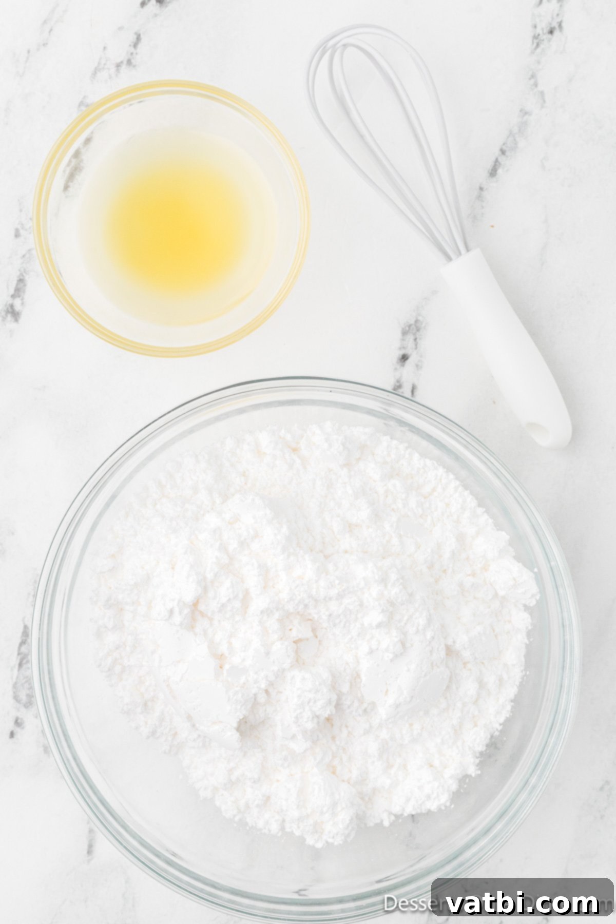 Powdered sugar and pineapple juice, the ingredients for the pineapple glaze, ready to be combined.