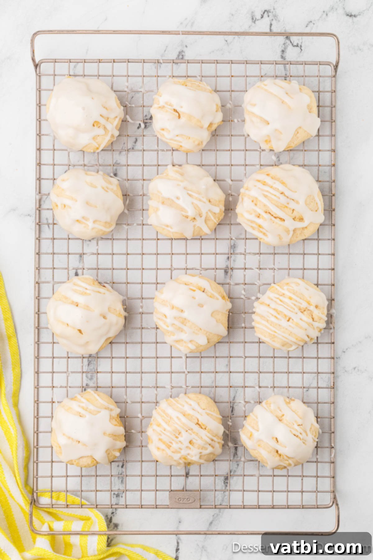 Cooled pineapple cookies on a wire rack, freshly topped with pineapple glaze.