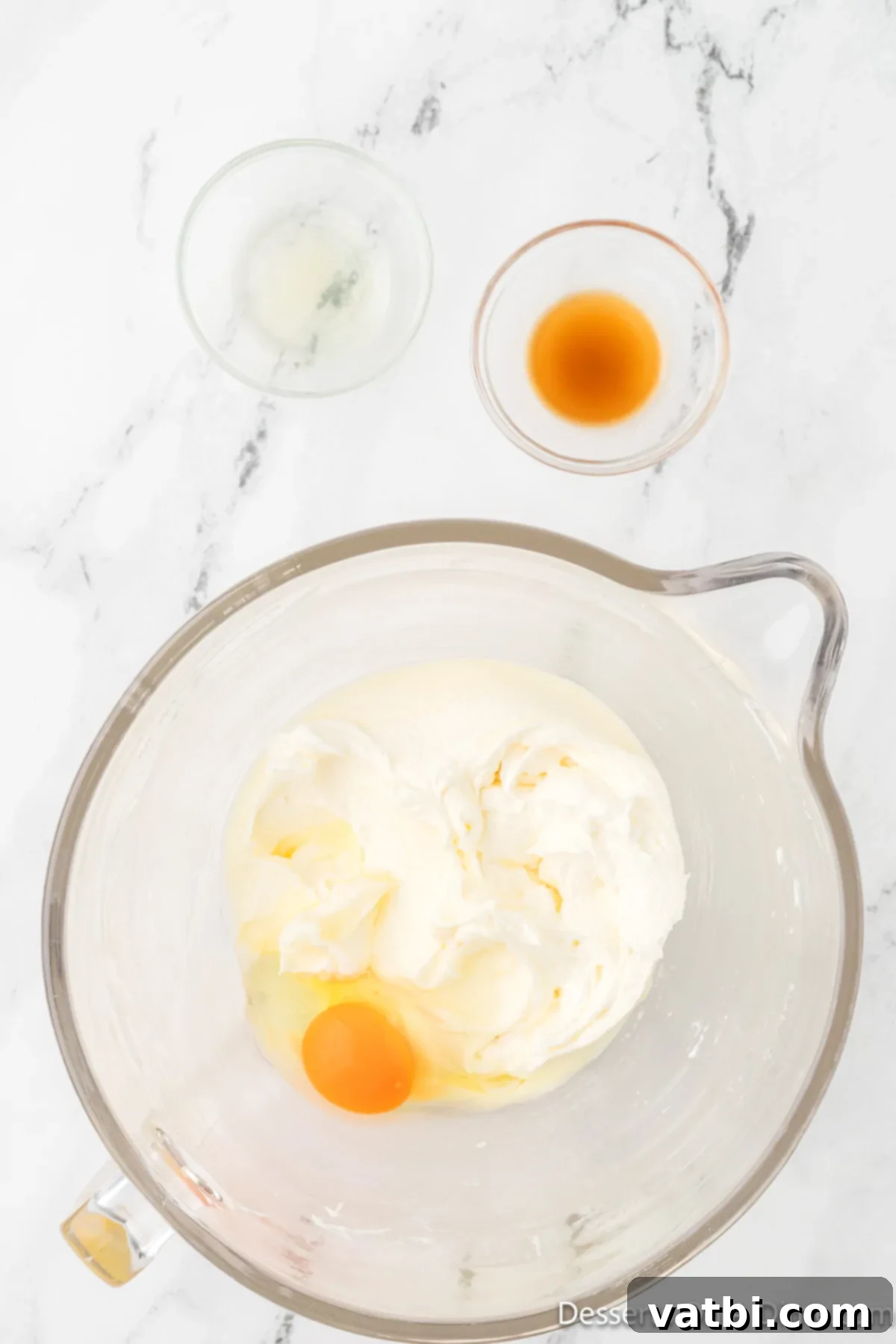 Sugar, eggs, vanilla extract, and pineapple juice added to the creamed butter and cream cheese mixture.