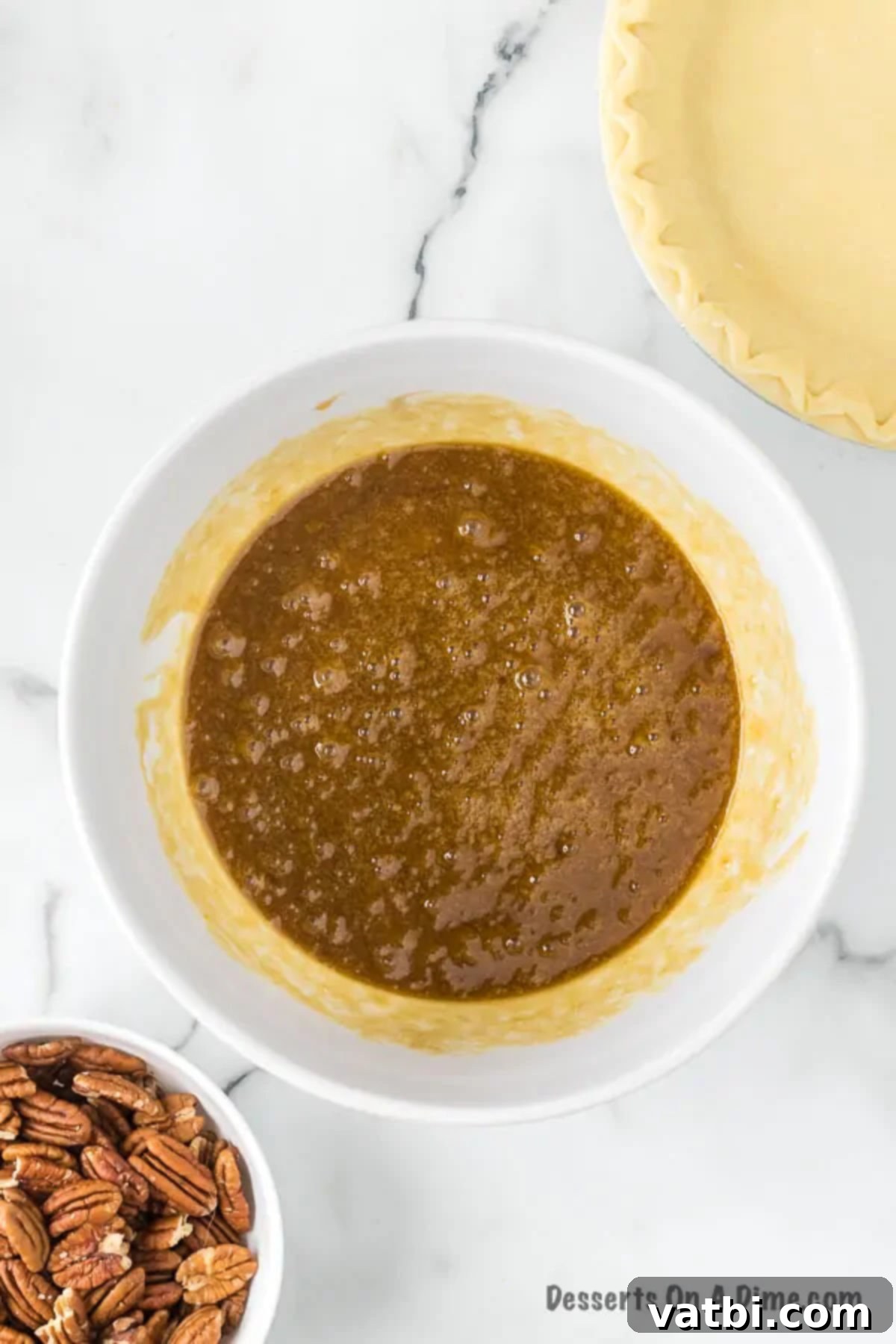 Effortless Pecan Pie Perfection 4 Bowl of eggs, corn syrup and sugar combined.