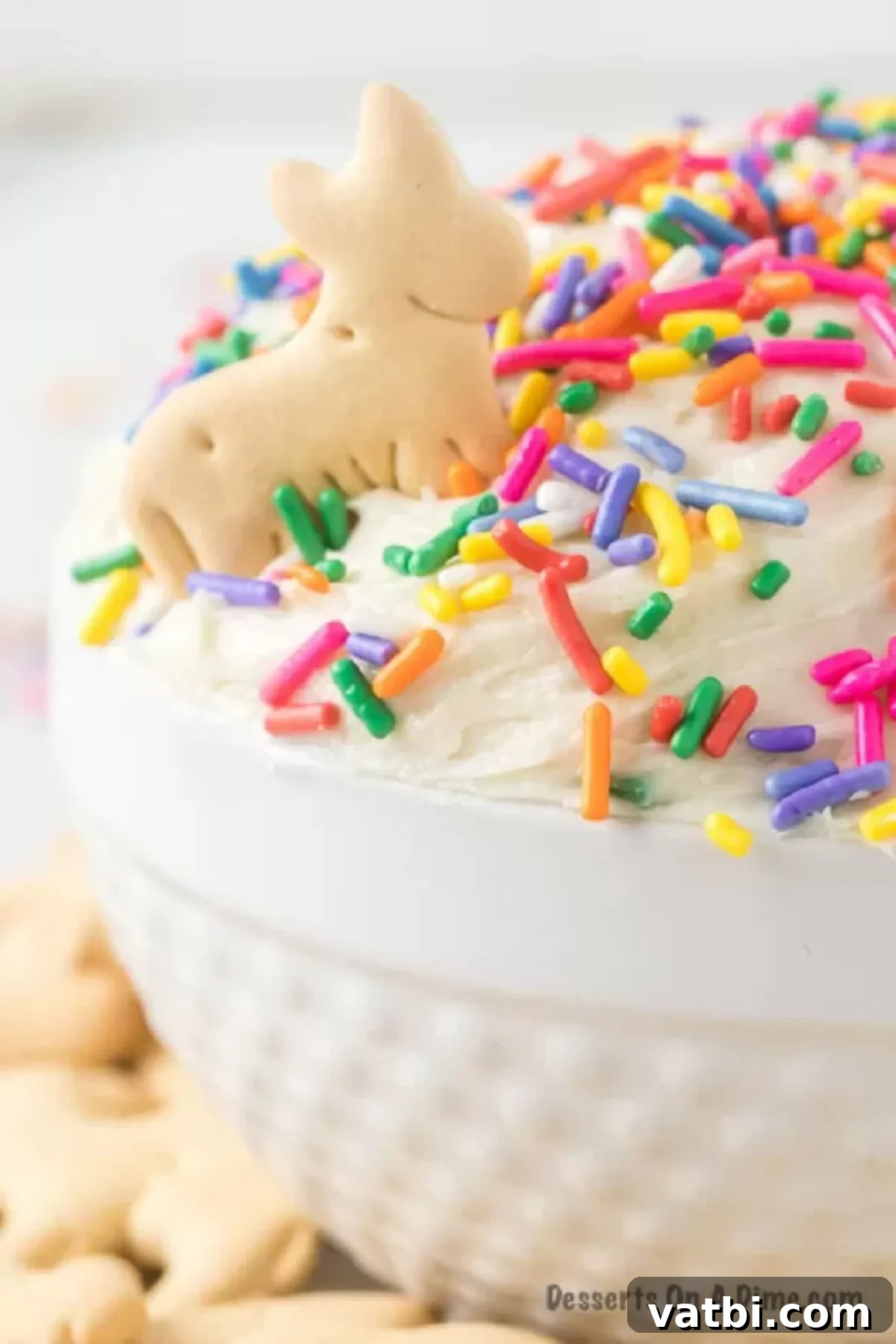 Party Cake Batter Delight 2 A beautifully presented bowl of Funfetti Dip, generously topped with colorful rainbow sprinkles, ready to be served at a party.