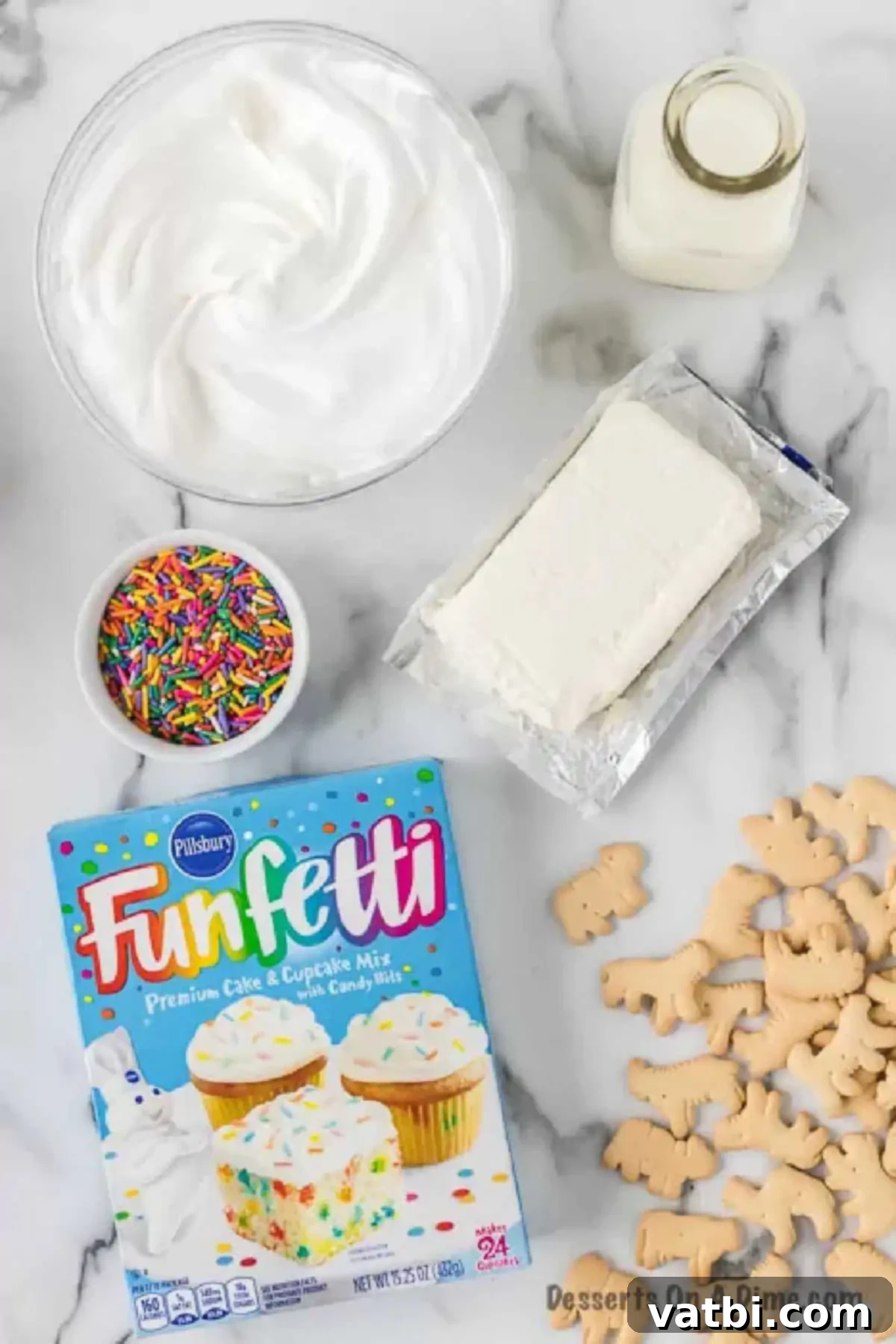 Party Cake Batter Delight 3 A flat lay showing the five key ingredients for Funfetti Cake Batter Dip: softened cream cheese, thawed Cool Whip, milk, Funfetti cake mix, and a generous amount of colorful sprinkles.