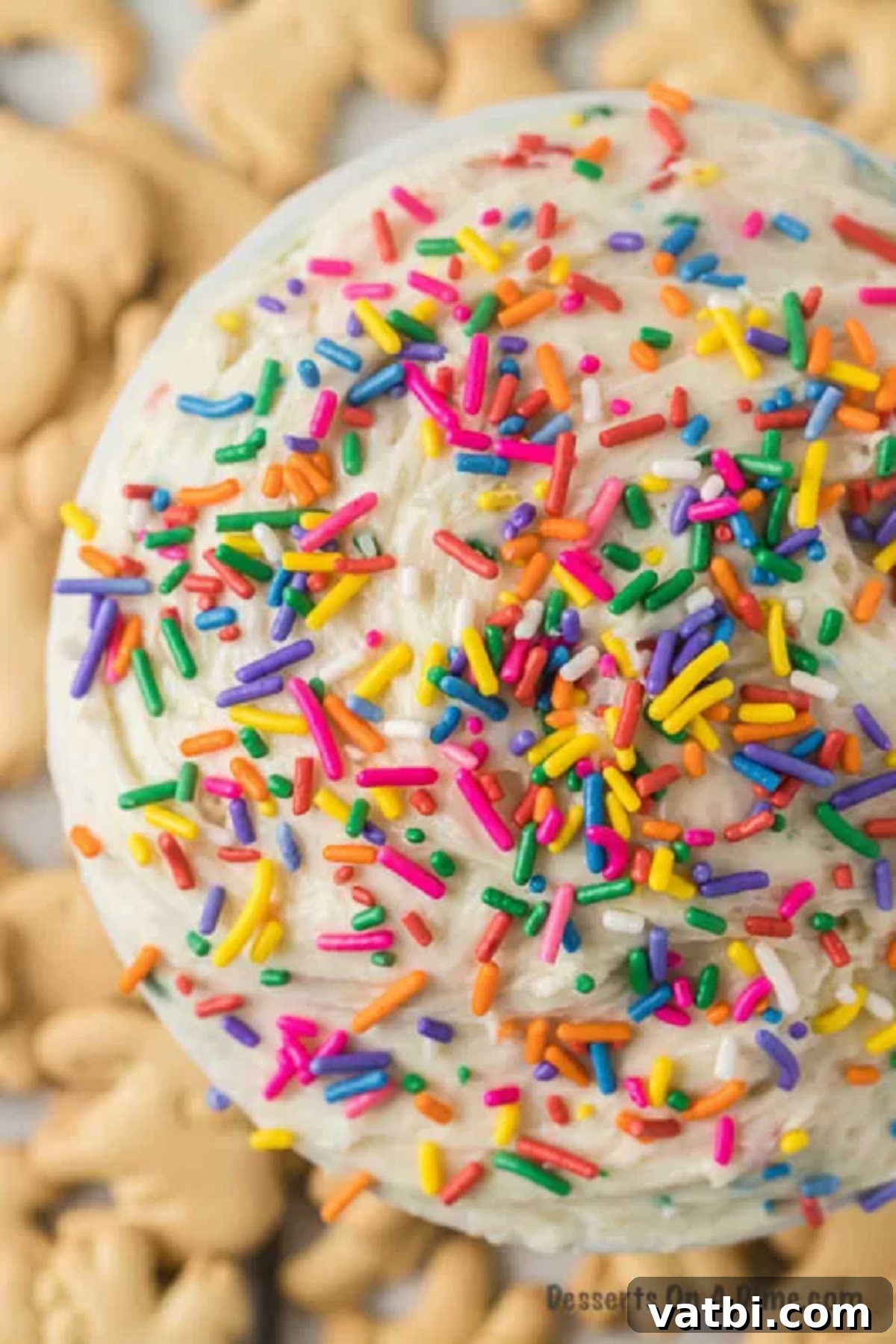Party Cake Batter Delight 4 A vibrant bowl of homemade Funfetti Cake Batter Dip, generously topped with a medley of colorful sprinkles, waiting to be enjoyed with dippers.