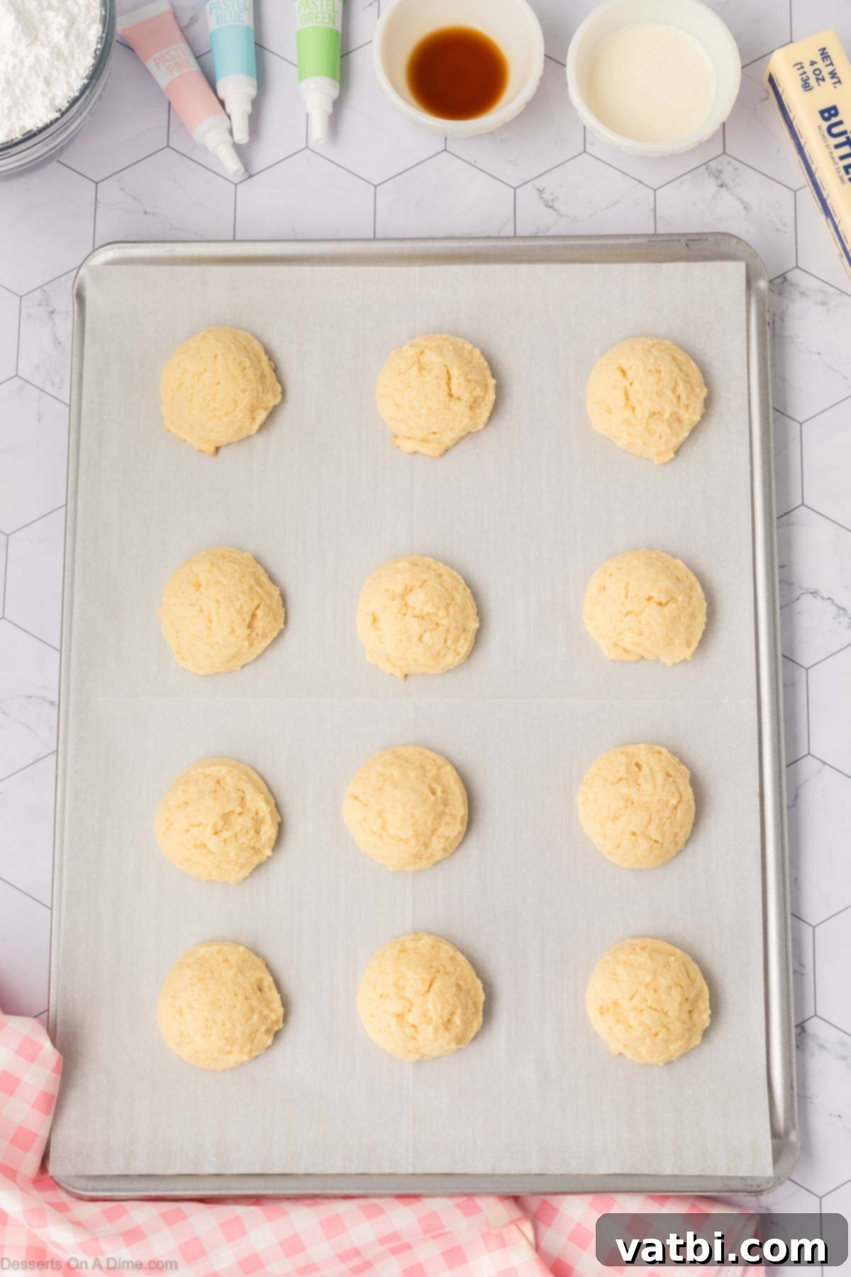 Soft Sour Cream Sugar Cookies 10 Cookie dough balls scooped onto a baking sheet.