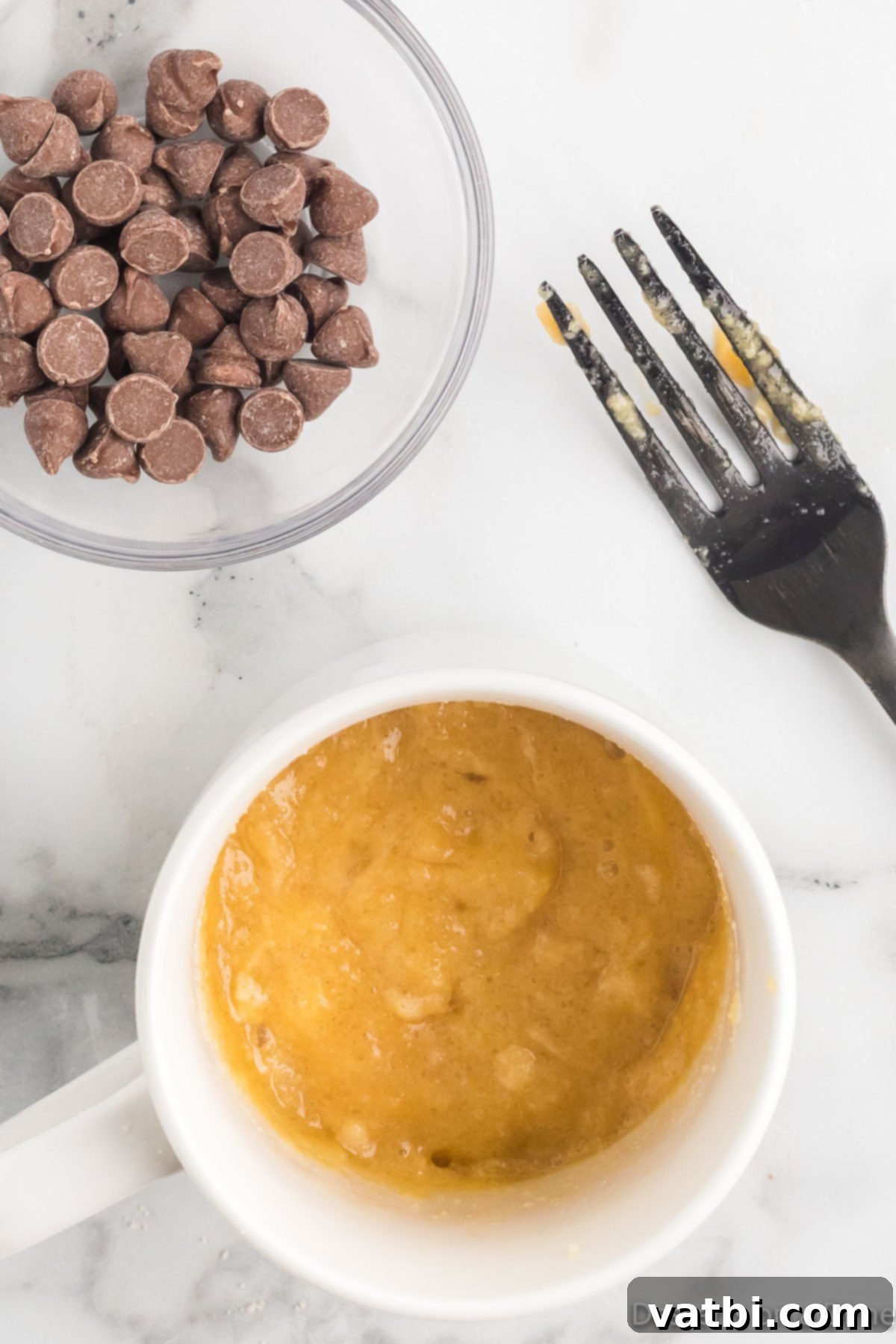 Guilt-Free Keto Chocolate Chip Mug Cake 5 Mug with keto mug cake batter combined, ready for chocolate chips.