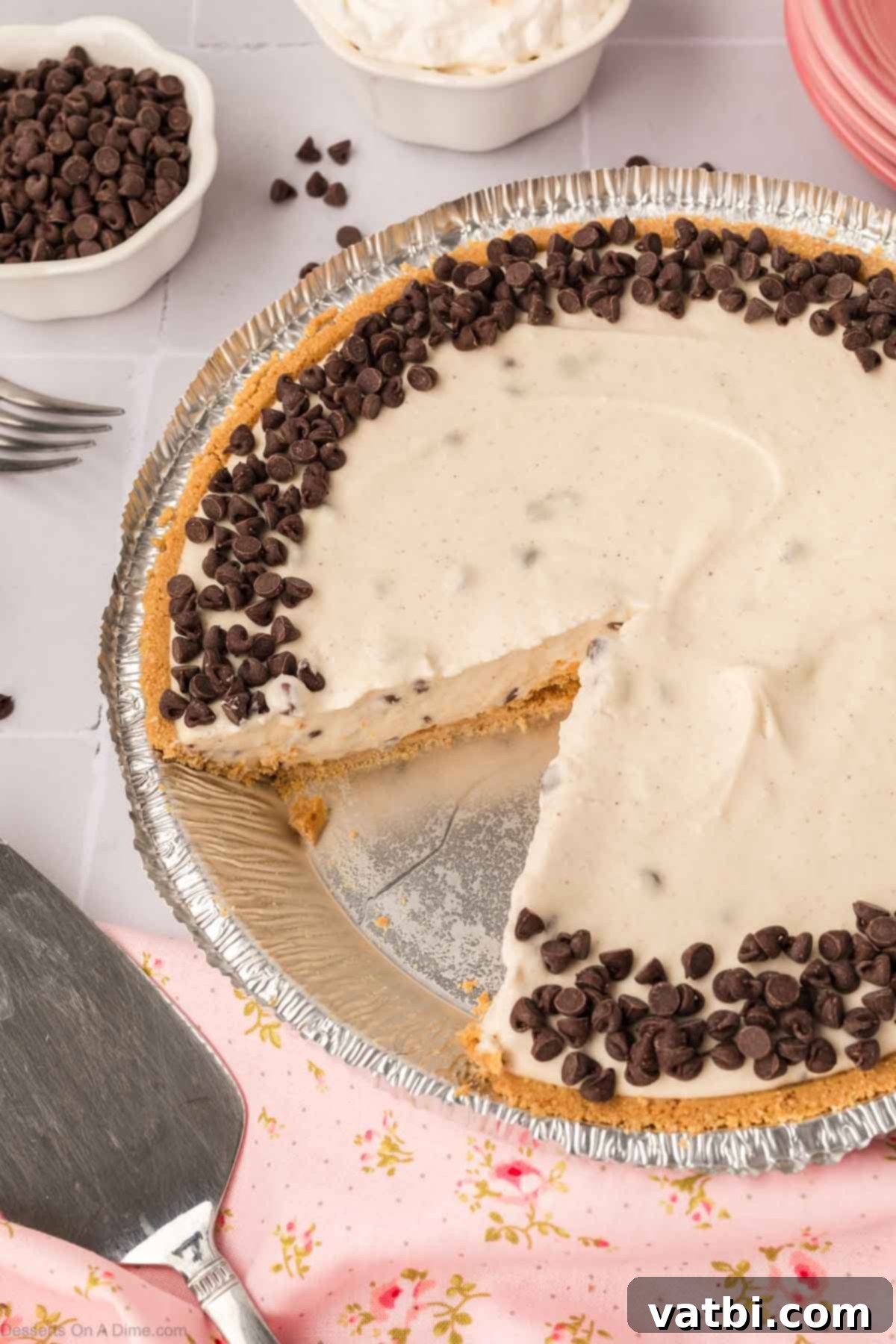 Decadent Cannoli Pie 2 A beautifully sliced no-bake Cannoli Pie, showcasing its creamy filling and chocolate chip garnish.