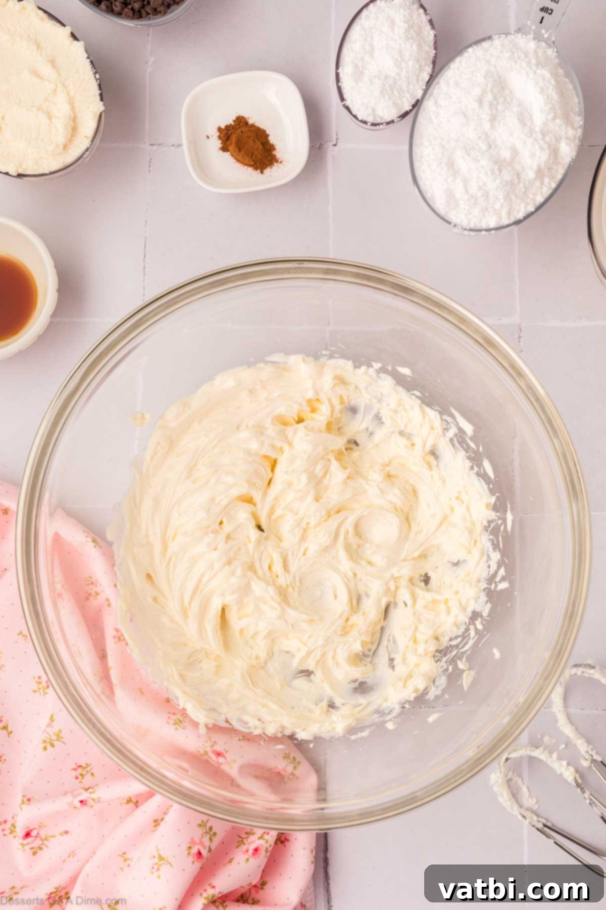 Decadent Cannoli Pie 4 Cream cheese being beaten in a mixing bowl until light and fluffy.