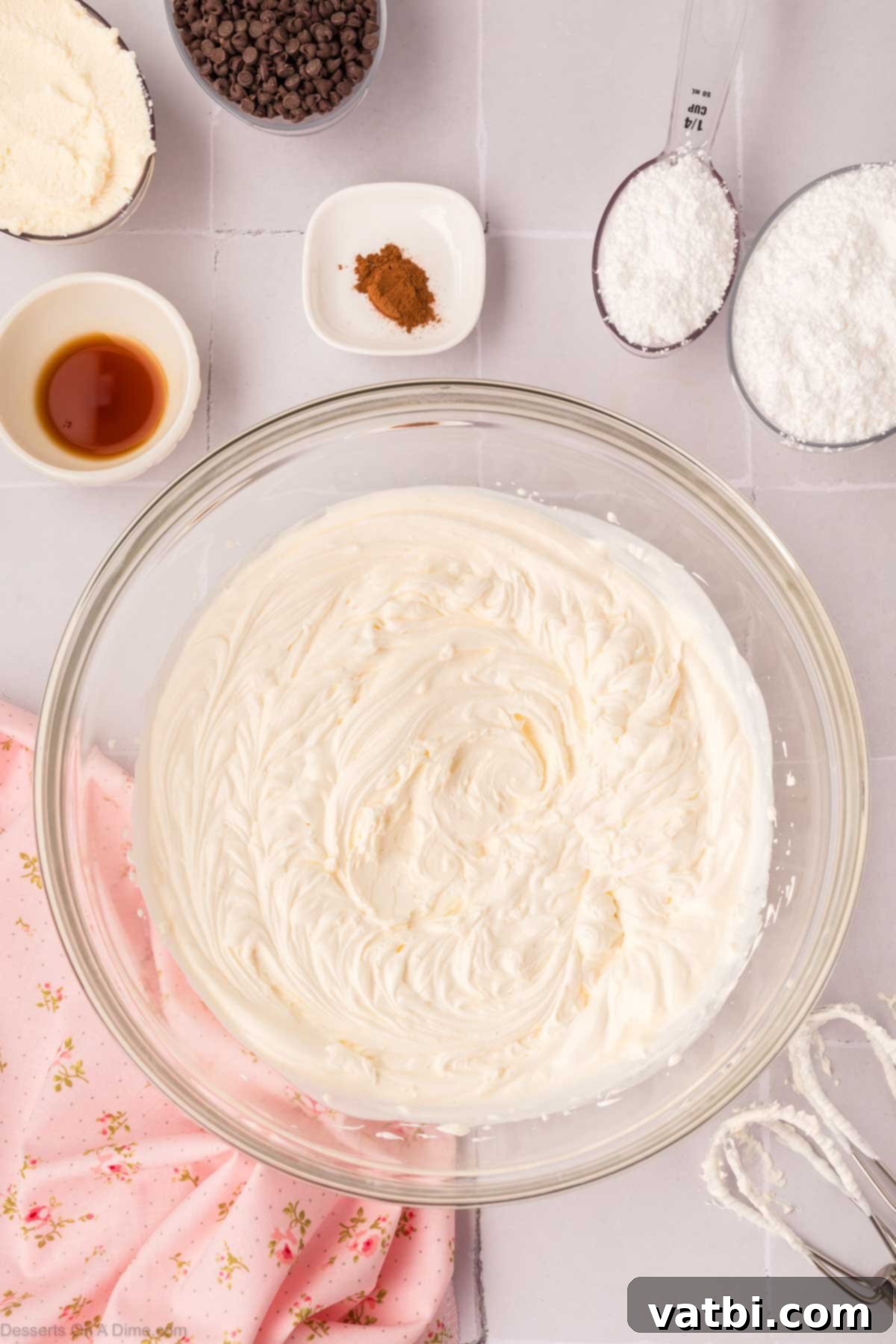 Decadent Cannoli Pie 6 Ricotta cheese, powdered sugar, and cinnamon being mixed into the cream cheese and heavy cream mixture.