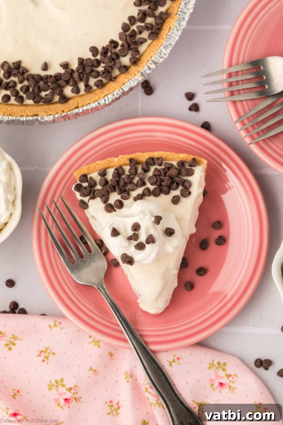 Decadent Cannoli Pie 10 A perfectly portioned slice of Cannoli Pie on a white plate, topped with whipped cream and mini chocolate chips, ready to be enjoyed.