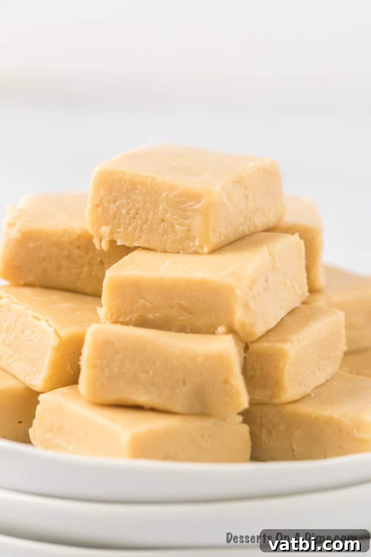 Homemade Salted Caramel Fudge 2 Salted Caramel Fudge cut into squares and stacked on a plate, showcasing its rich texture and beautiful appearance.