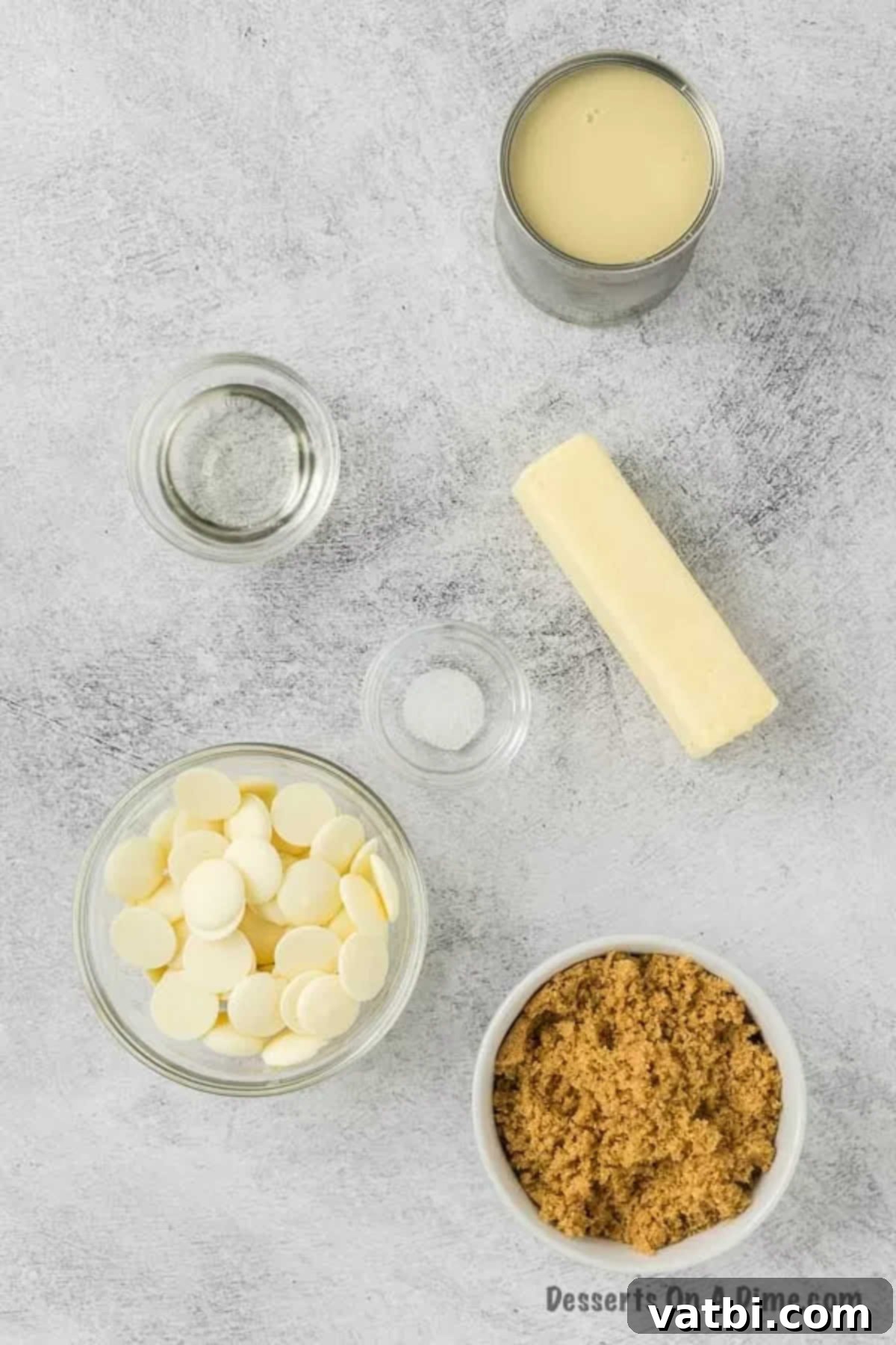Homemade Salted Caramel Fudge 3 Ingredients needed for Salted Caramel Fudge - Sweetened Condensed Milk, Brown Sugar, Unsalted Butter, Corn Syrup, Salt, White Chocolate Melts laid out on a table.