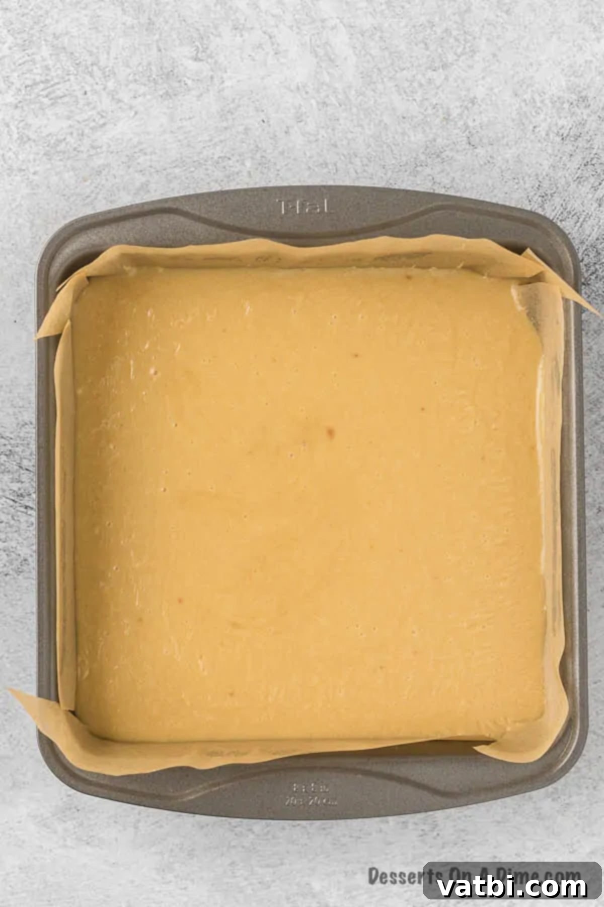 Homemade Salted Caramel Fudge 6 Step 3: Salted caramel fudge mixture poured into a parchment-lined baking pan.