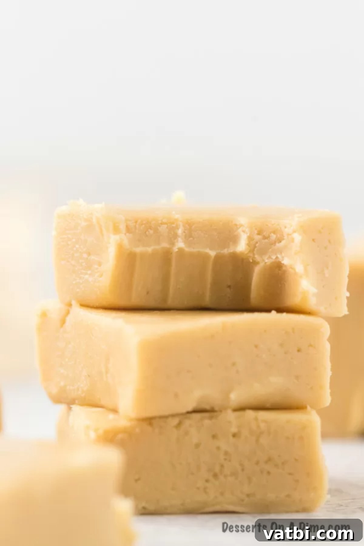 Homemade Salted Caramel Fudge 8 Stacked salted caramel fudge squares, showing the beautiful layers and inviting texture.