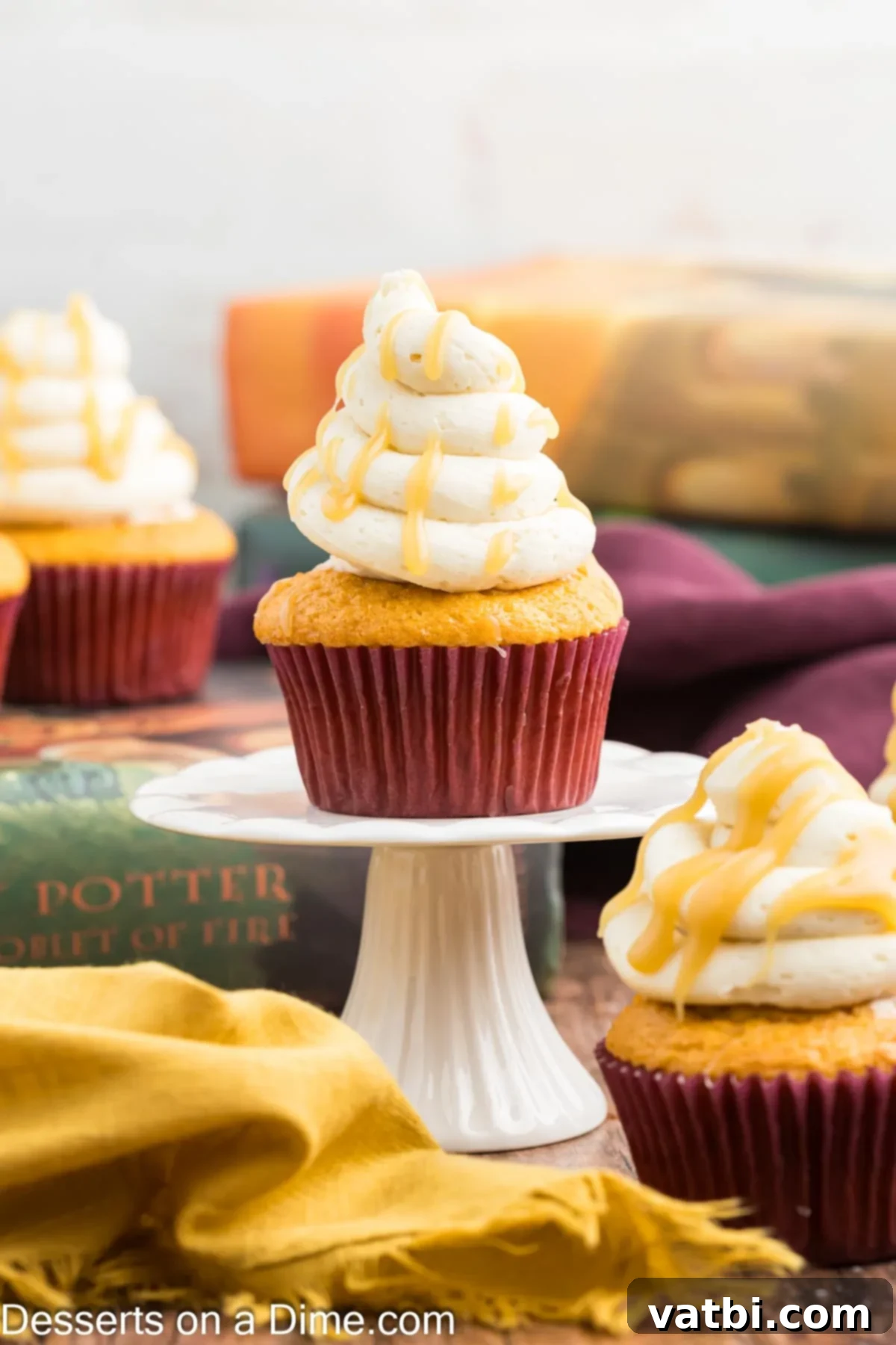 Magical Harry Potter Cupcakes 12 A single Harry Potter Butterbeer cupcake with butterscotch frosting on a small stand, ready to be enjoyed.