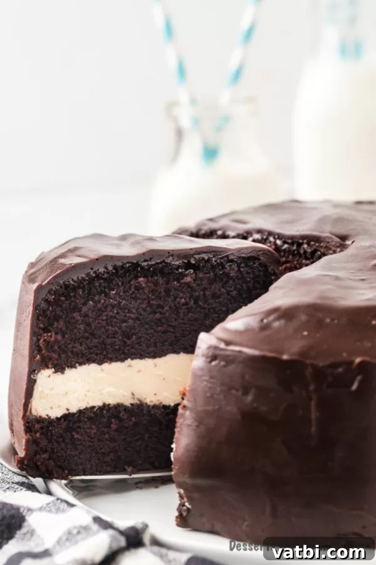 Ding Dong Cake 2 Ding Dong Cake with one slice out, showcasing rich chocolate layers and creamy white filling.