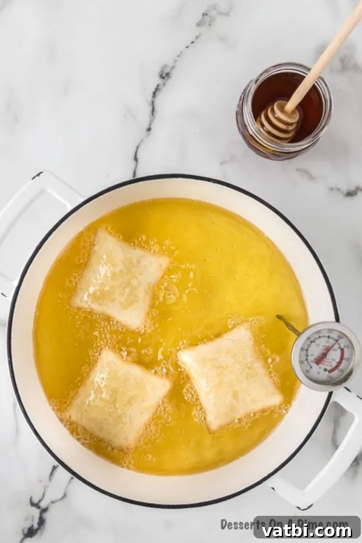 Golden & Fluffy Sopapillas: The Perfect Sweet Treat 10 Sopapilla dough frying in hot oil, puffing up.