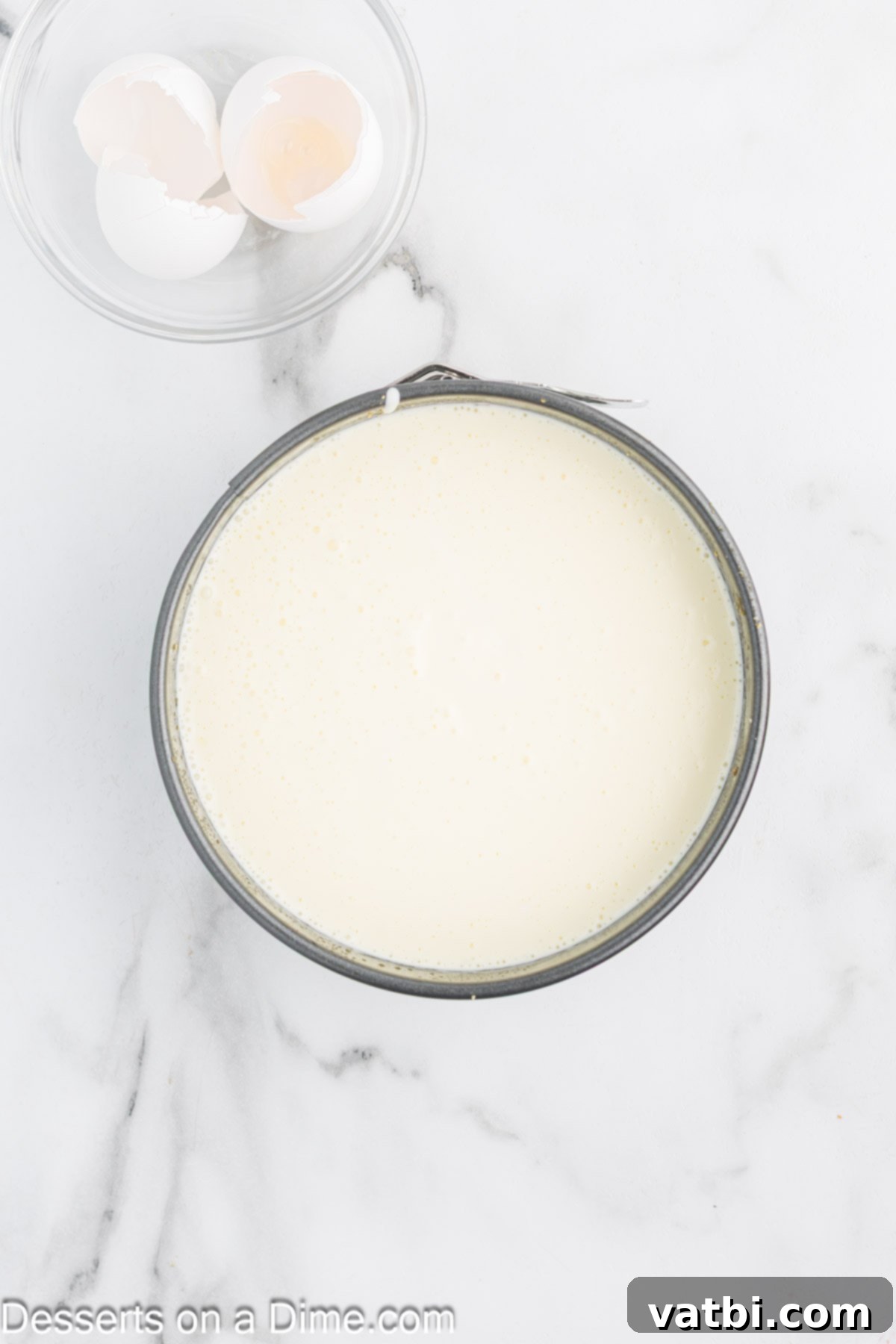 Rustic Farmhouse Cheesecake 7 Smooth cheesecake filling being poured over the cooled, baked crust in a springform pan.