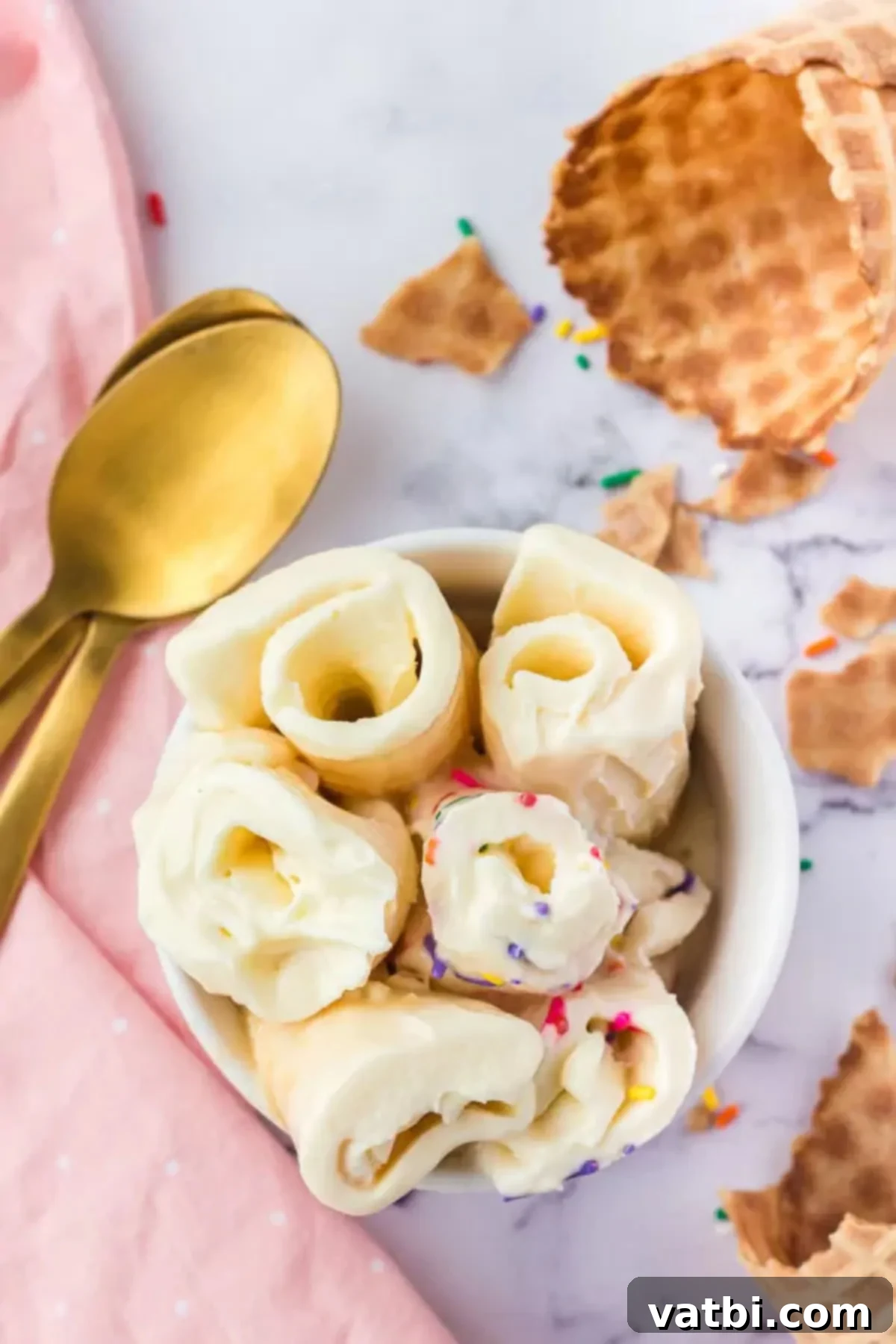 Homemade Rolled Ice Cream Fun 2 Delicious rolled ice cream in a bowl, topped with colorful sprinkles and waffle cones.