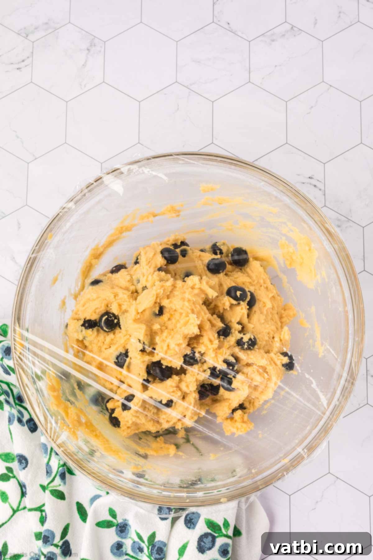 Delicious Blueberry Cookies 9 Plastic wrap covering dough in bowl.