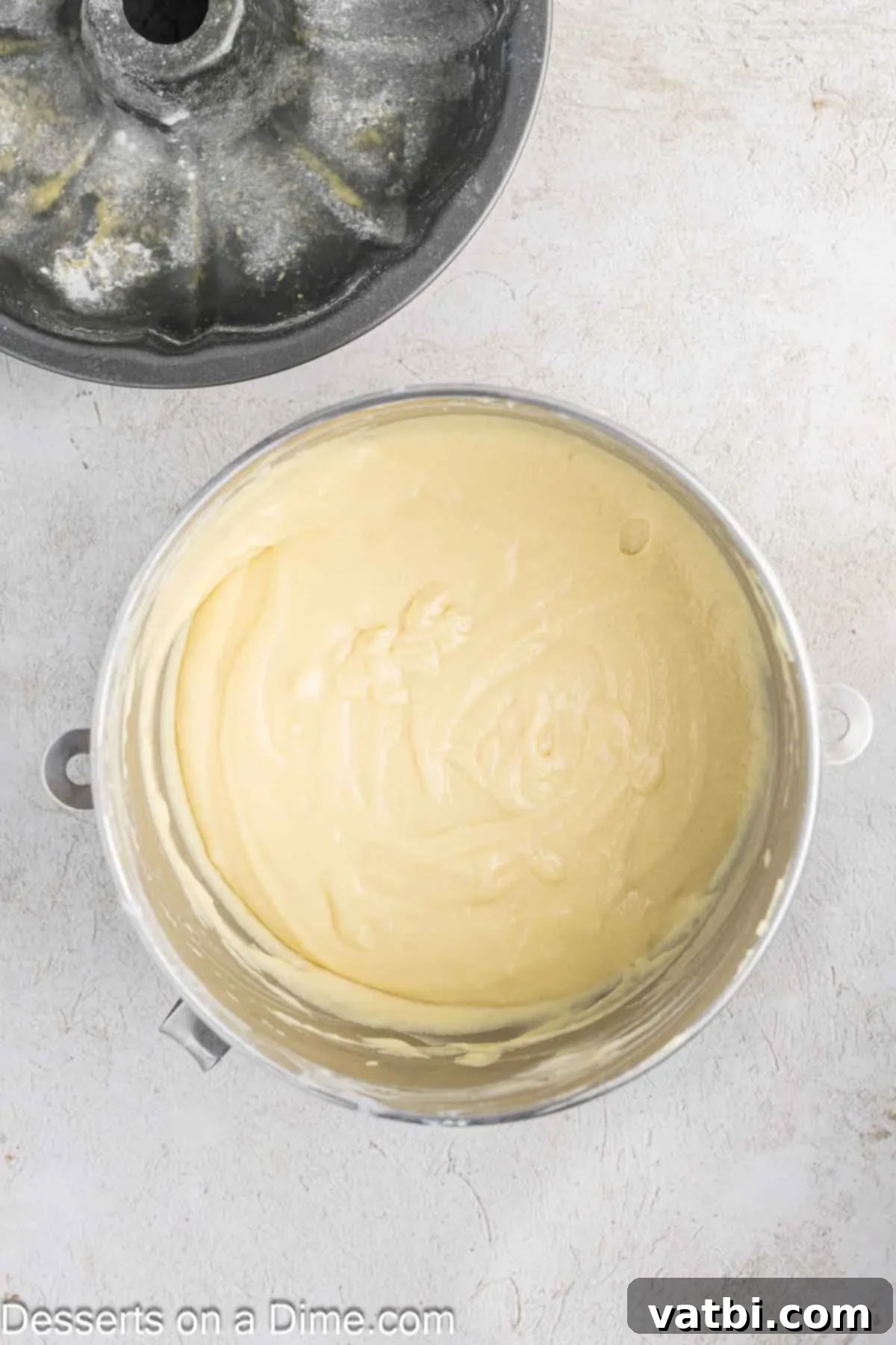 Donut Cake Delight 5 Room temperature eggs being incorporated one by one into the creamed butter and sugar mixture in a stand mixer.