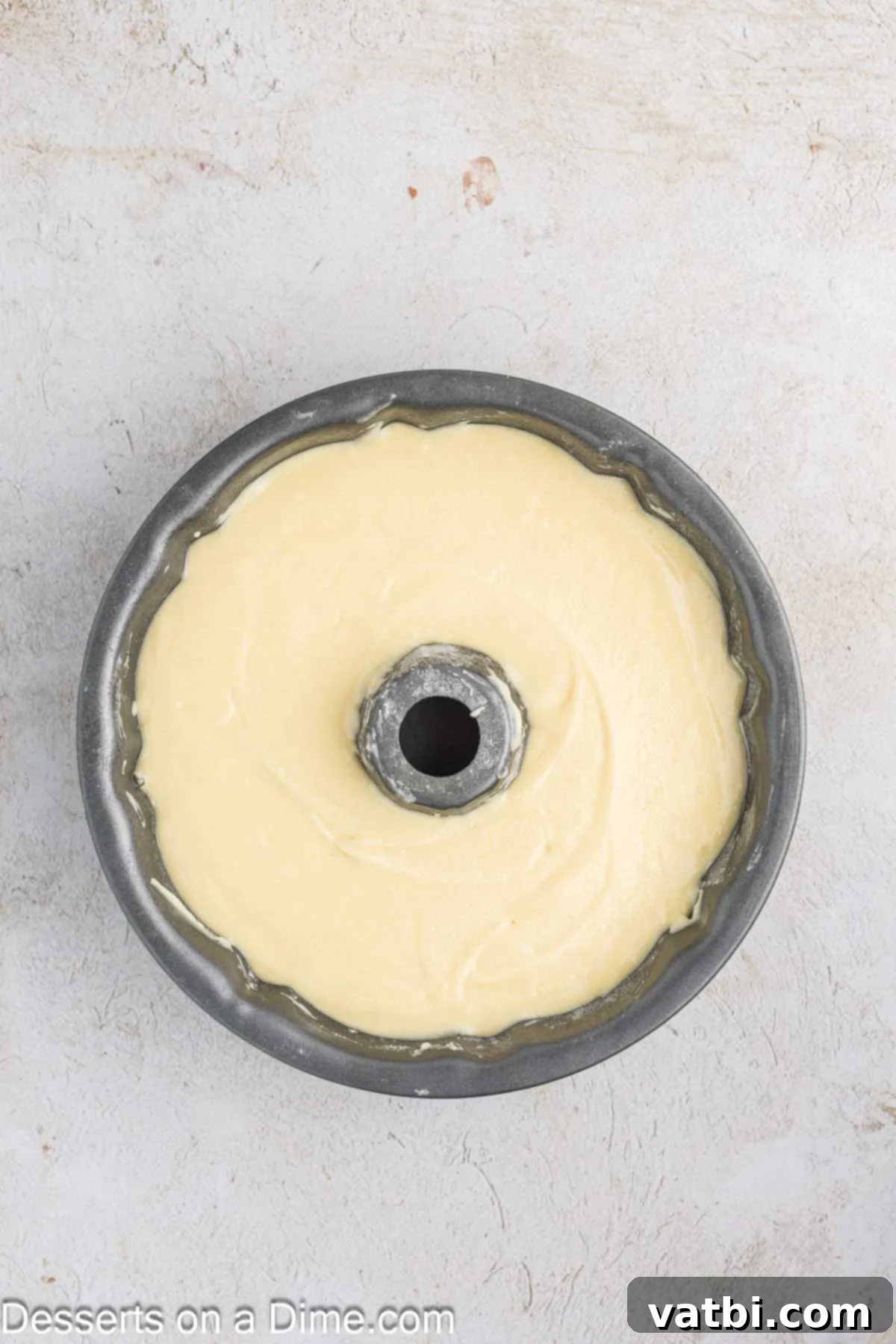 Donut Cake Delight 6 Smooth cake batter being poured evenly into a prepared bundt pan, ready for baking.