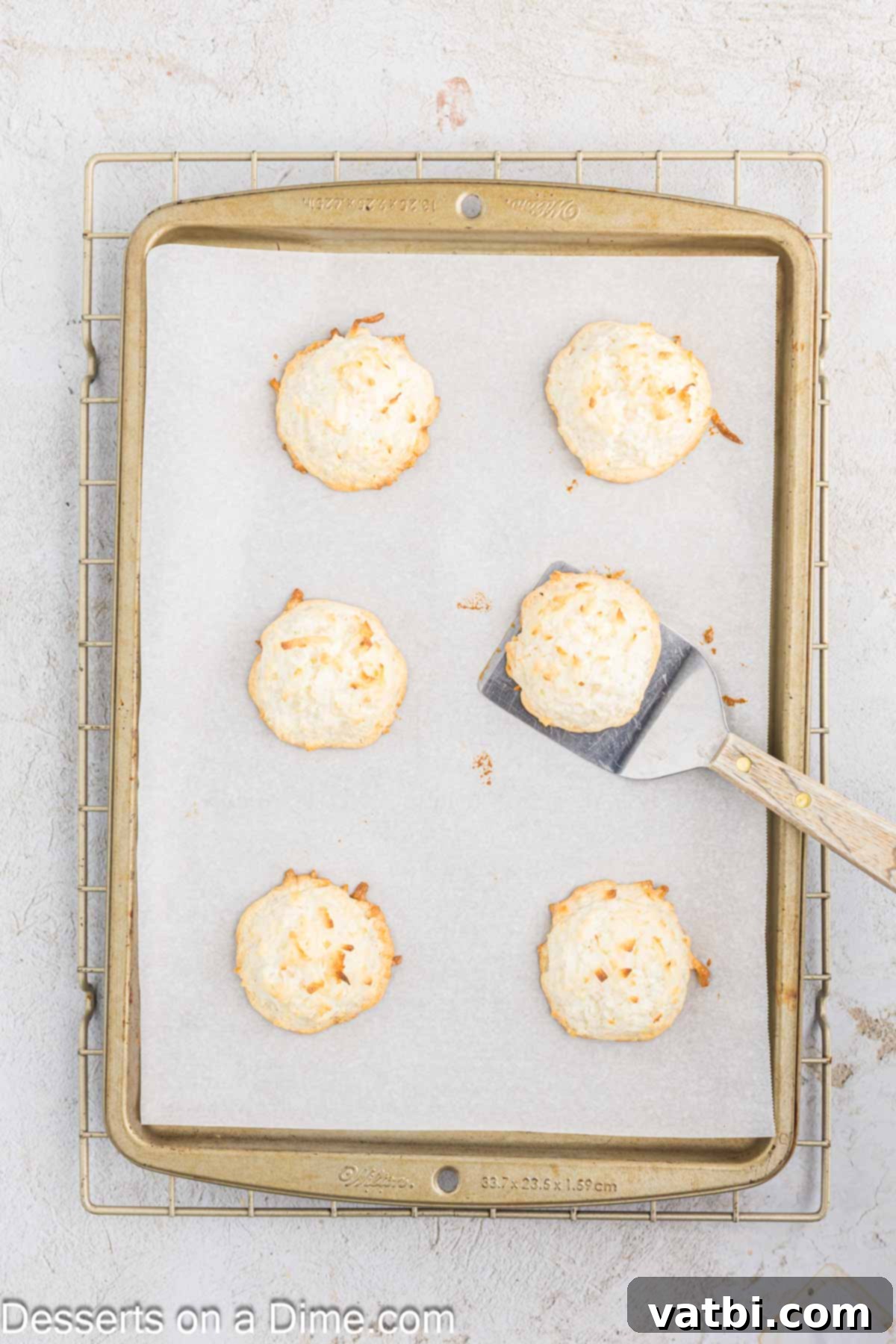 Chewy Coconut Macaroons 8 Coconut Macaroons on a baking sheet.