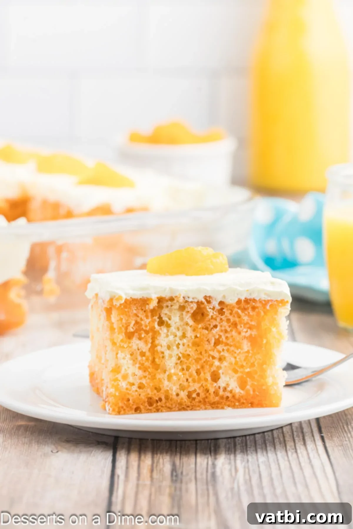 Orange Creamsicle Cake 11 A slice of Orange Creamsicle Cake on a plate, showing the distinct orange and white layers.