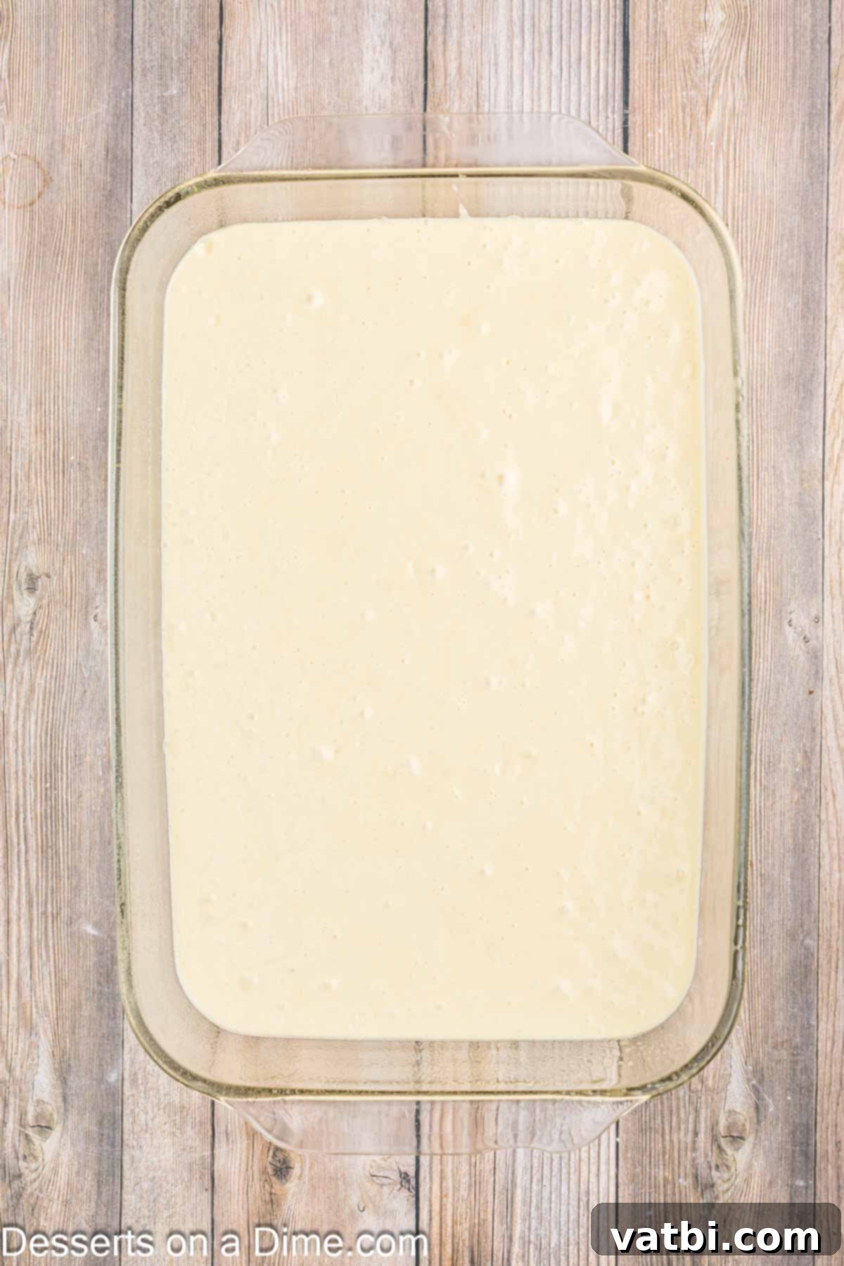 Orange Creamsicle Cake 5 Smooth cake batter poured into a 9x13 inch baking pan, ready to be baked.