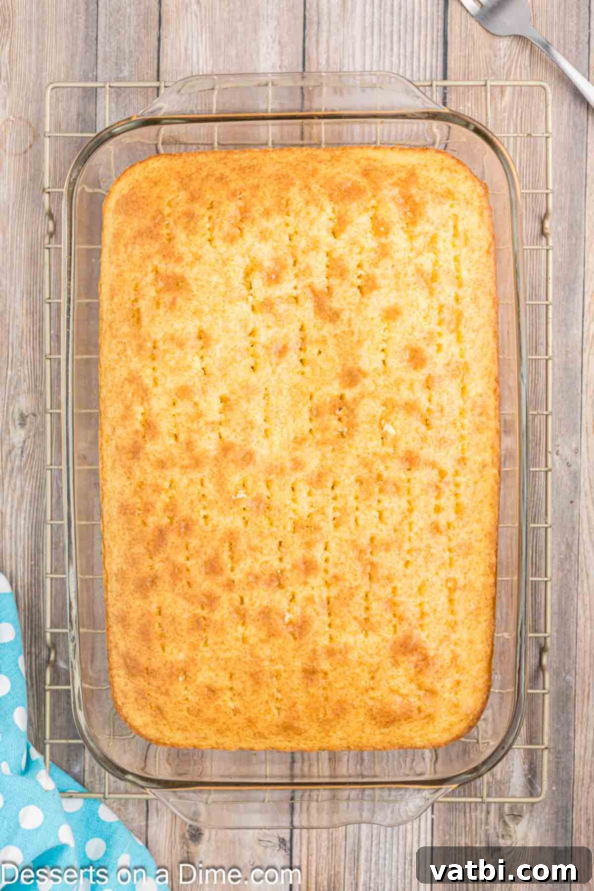 Orange Creamsicle Cake 7 Cake with many holes poked evenly across its surface, ready for gelatin.