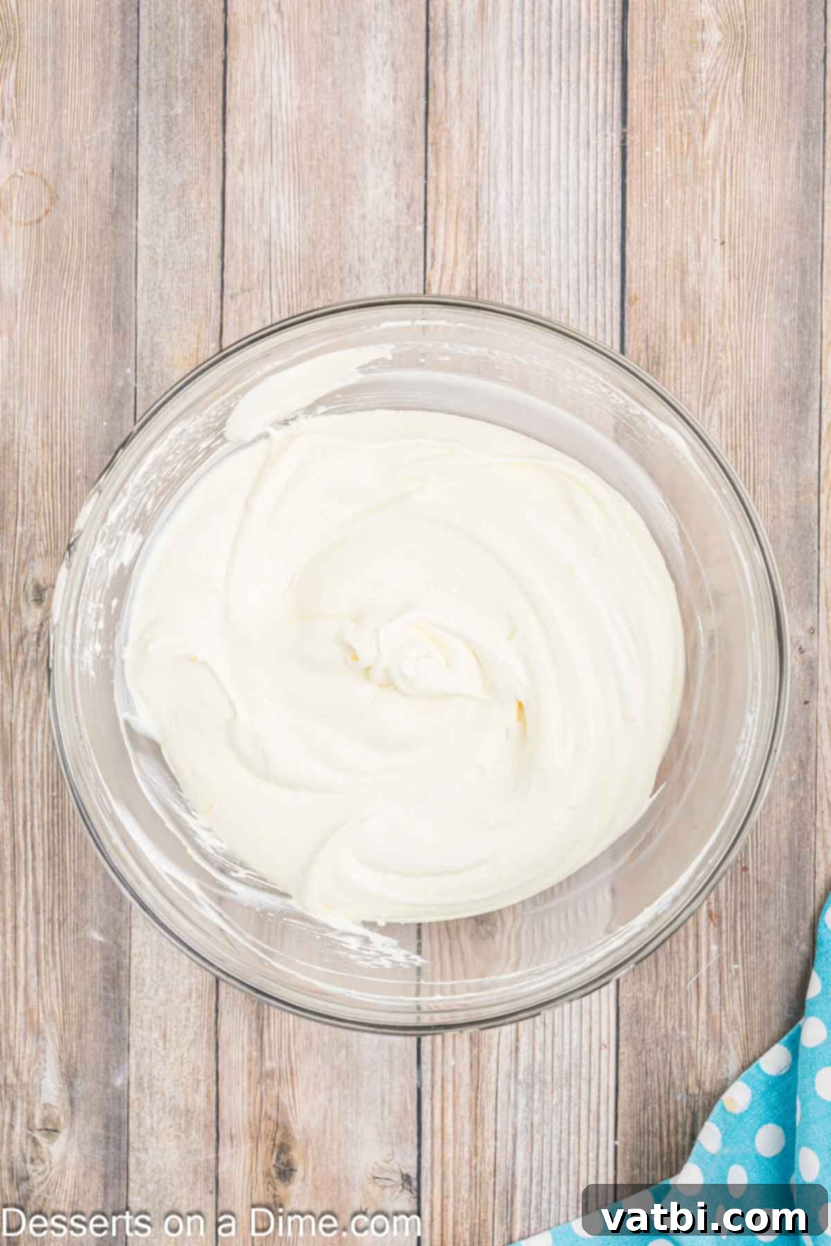 Orange Creamsicle Cake 9 Creamy vanilla pudding and cool whip topping mixed together in a large bowl.