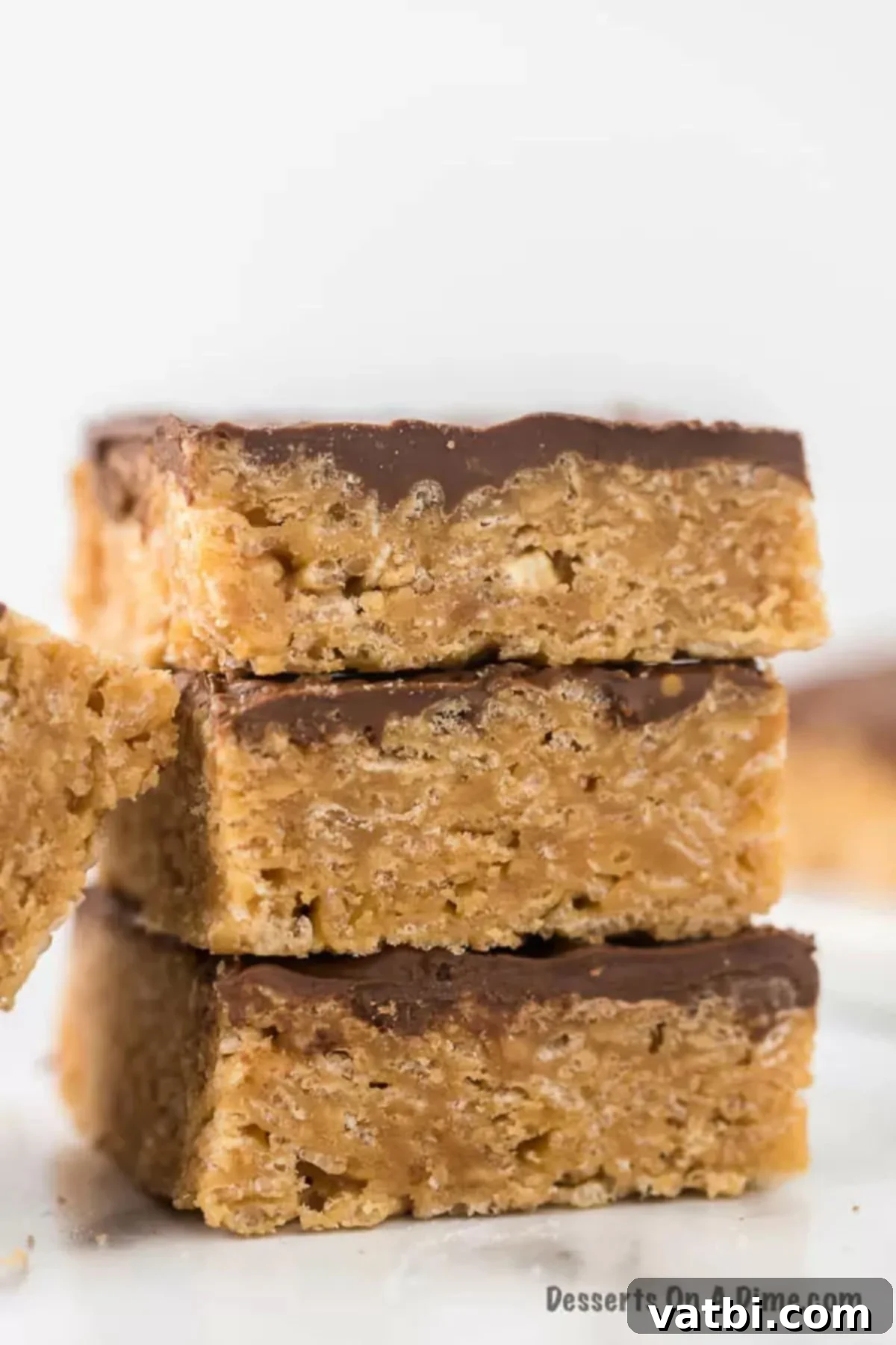 Perfectly cut Scotcheroos bars arranged on a platter, showcasing their chocolate and butterscotch topping over the cereal base.