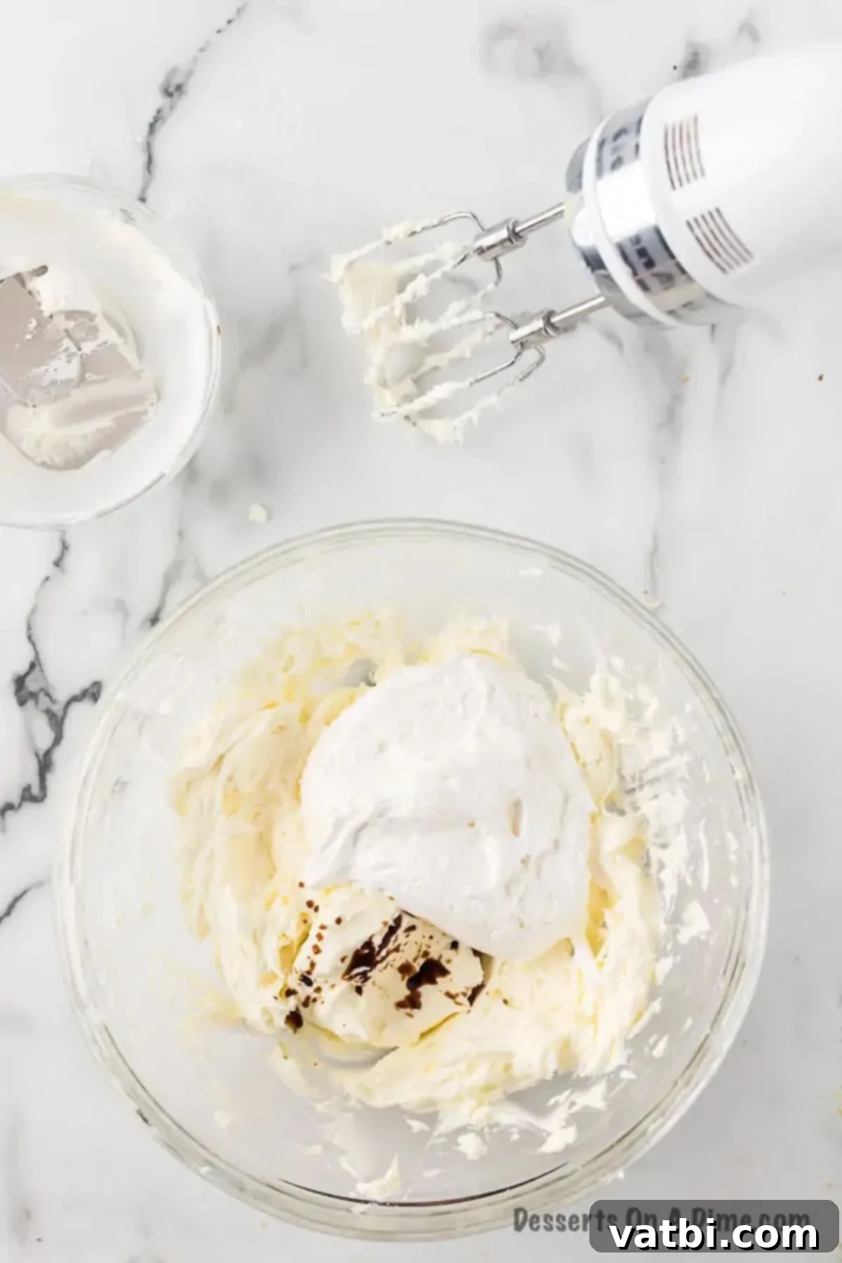 Gently mix in marshmallow fluff and vanilla extract into the butter and sugar mixture.