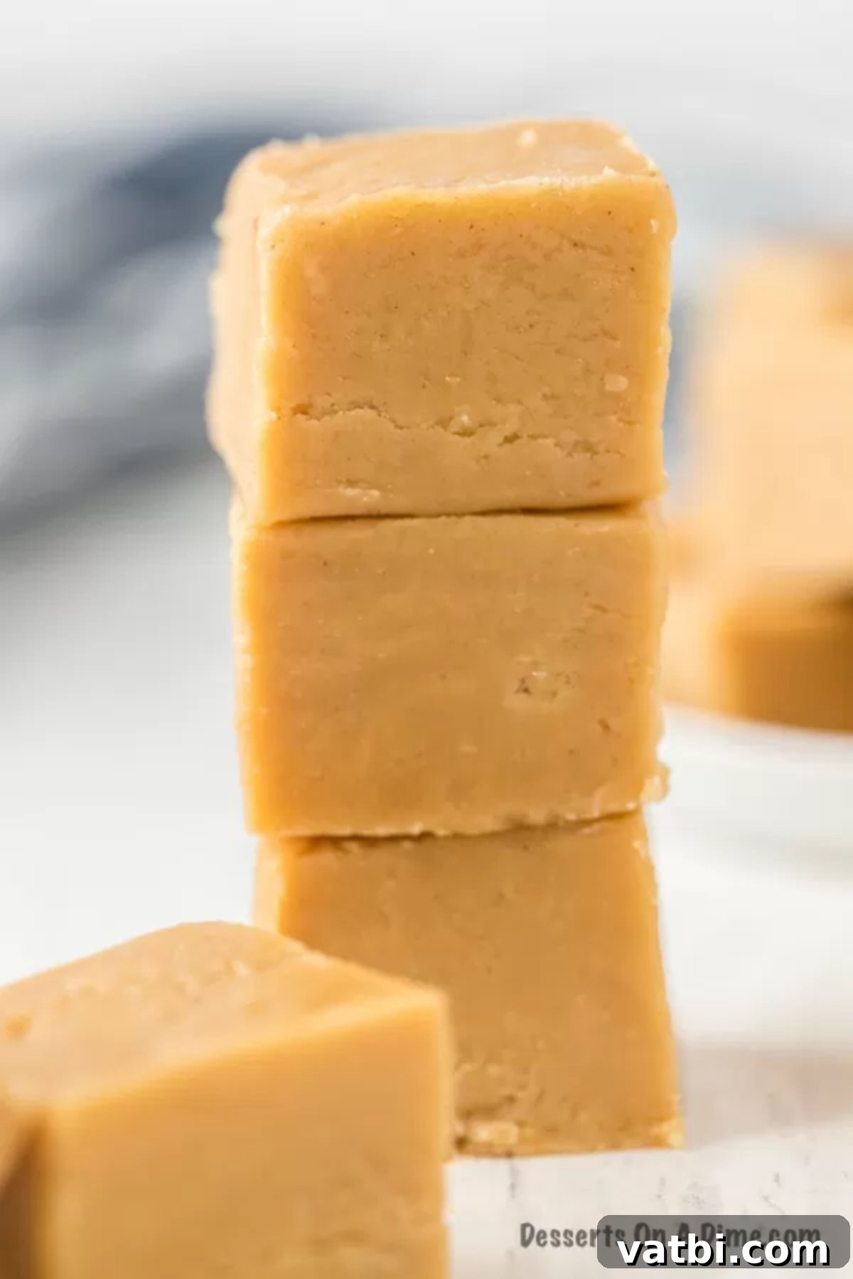 Easy 3-Ingredient Peanut Butter Fudge 2 Stacked squares of creamy homemade 3-ingredient peanut butter fudge, showing its rich texture.