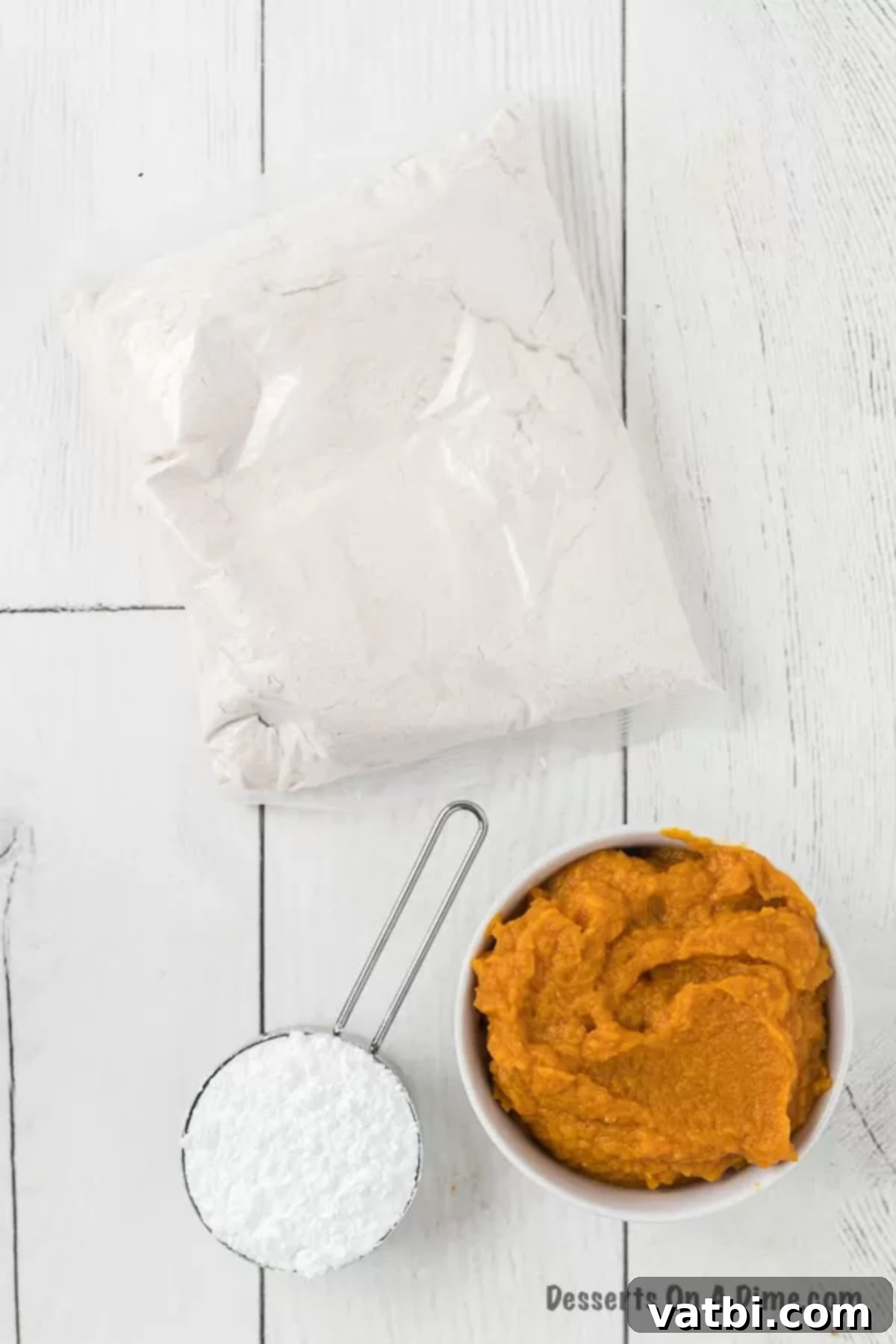 Ingredients to make these pumpkin cake mix cookies - pumpkin puree, spice cake mix, powdered sugar. 