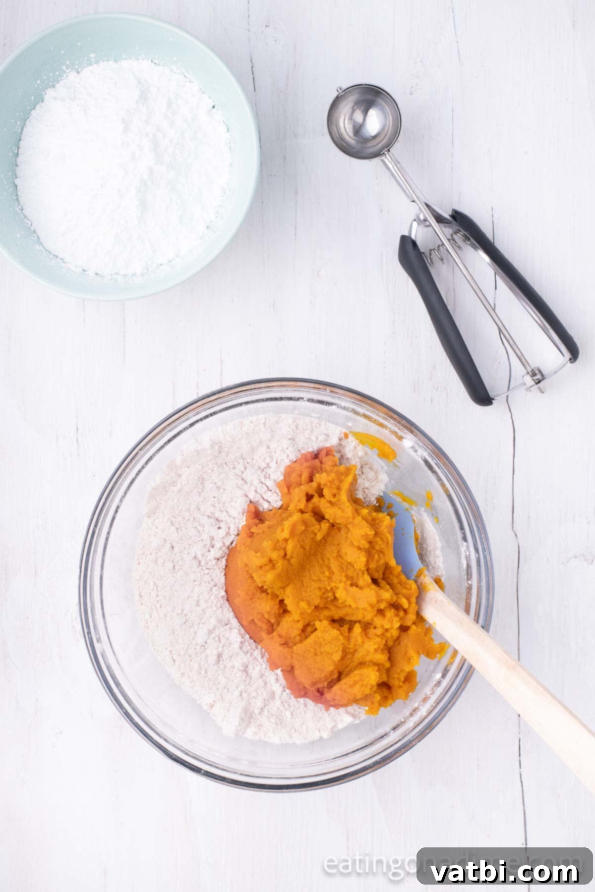 Mixing bowl with cake mix and pumpkin. 