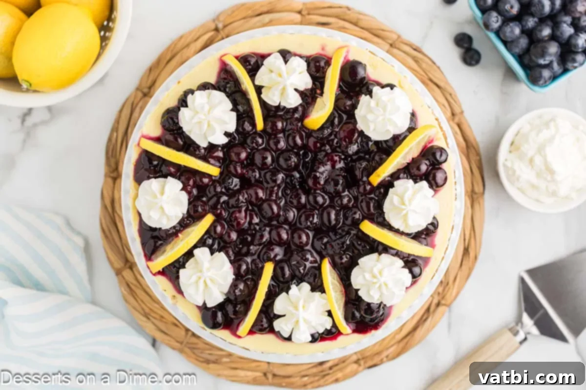 Luscious Lemon Blueberry Cheesecake 2 Lemon Blueberry Cheesecake topped with lemon slices and ready to serve, showcasing its golden crust and vibrant fruit.