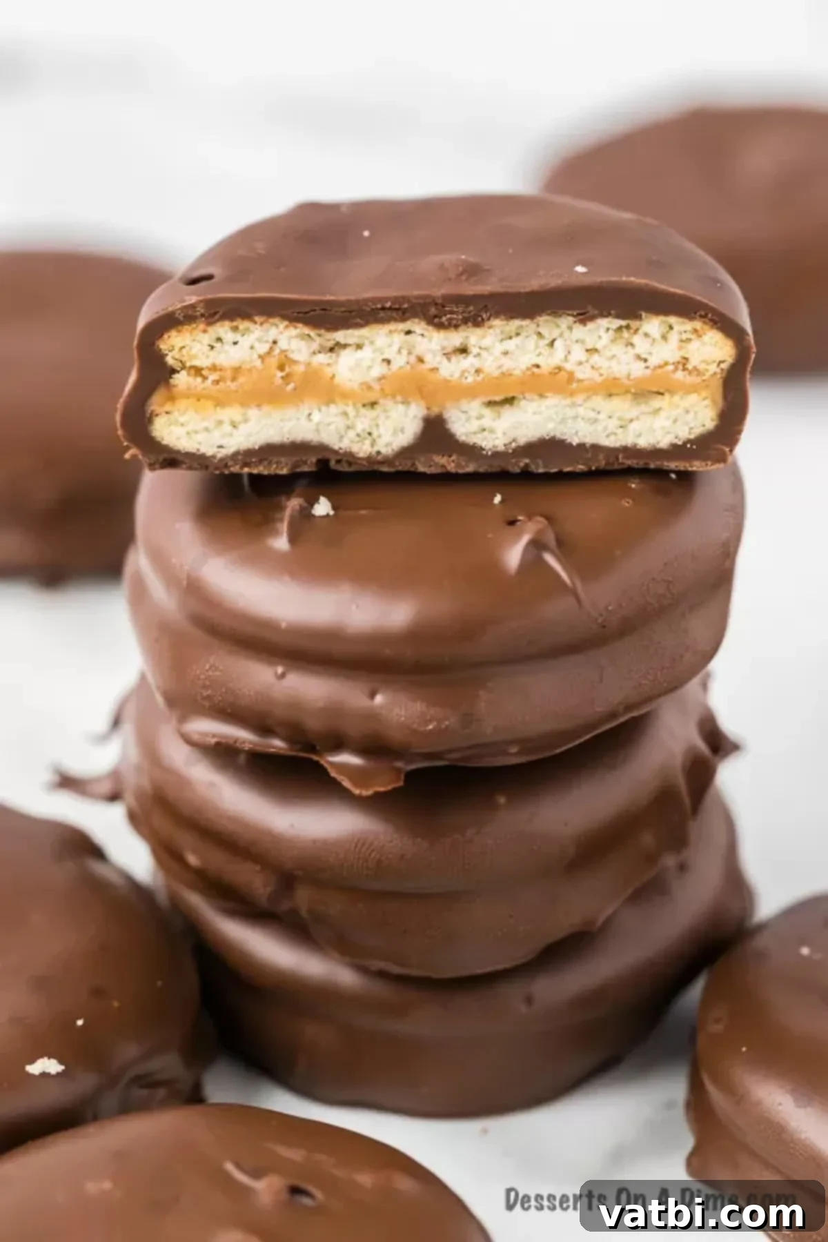 Sweet and Salty Chocolate Ritz Bites 2 A perfectly stacked arrangement of Chocolate Covered Ritz Crackers, showcasing their delightful peanut butter filling and smooth chocolate coating.