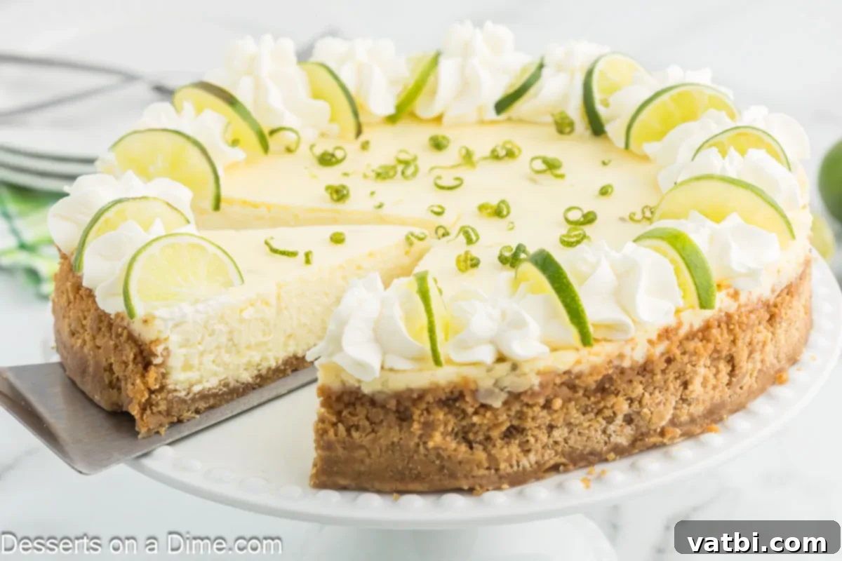 Key Lime Cheesecake 2 Key Lime Cheesecake being sliced, showcasing its creamy texture and golden-brown crust.