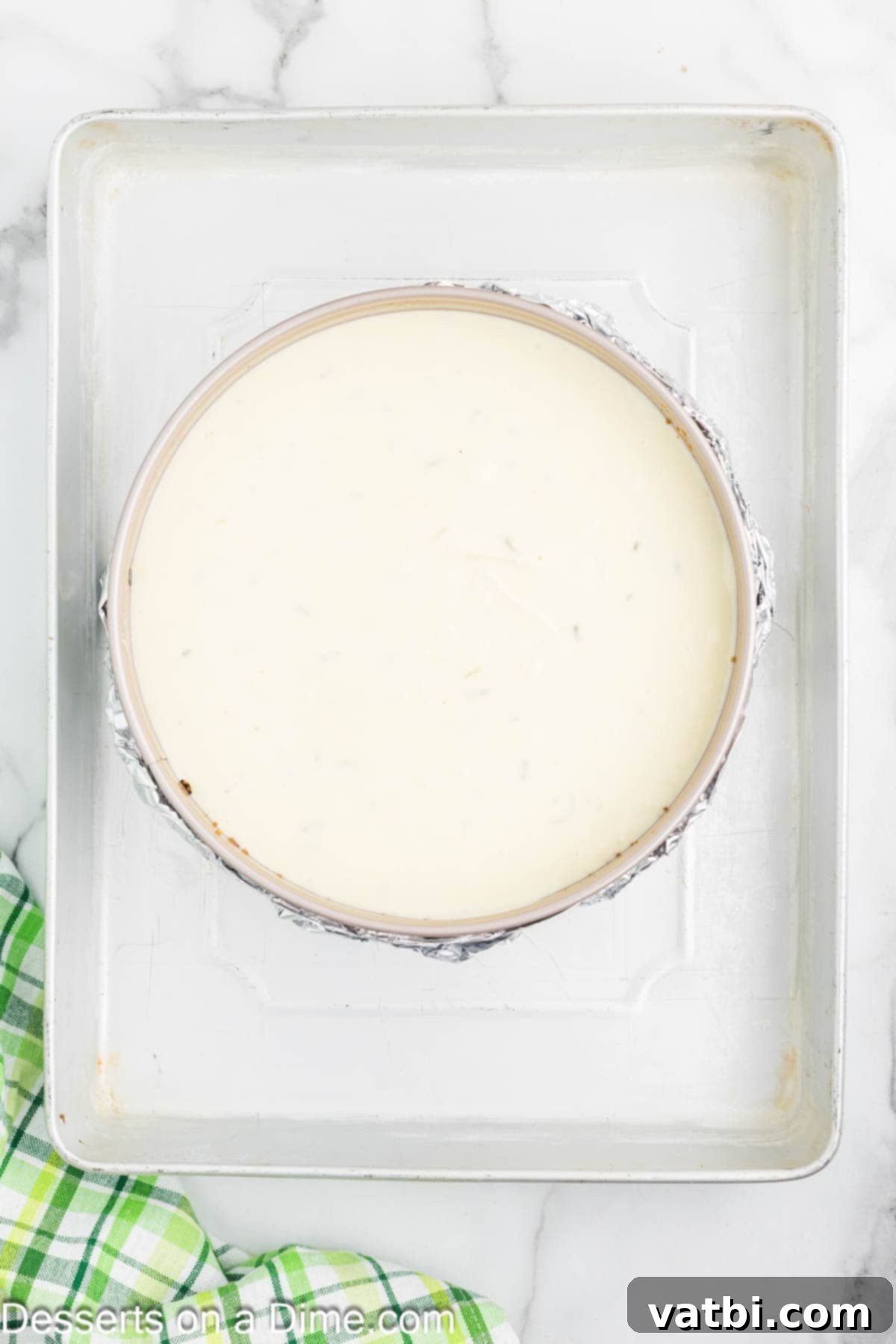 Key Lime Cheesecake 7 Cheesecake in a water bath inside a larger baking dish.