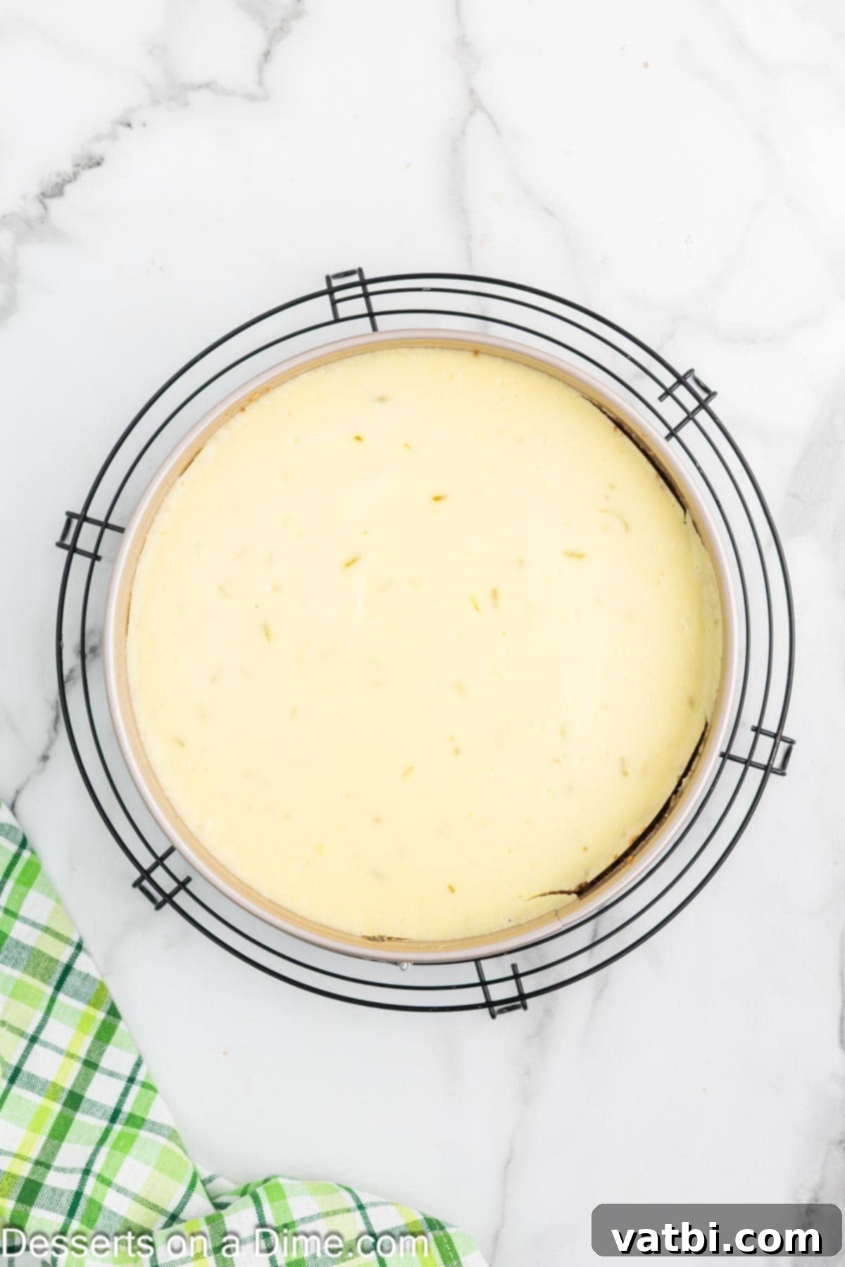 Key Lime Cheesecake 8 Baked cheesecake cooling in the oven with the door slightly ajar.