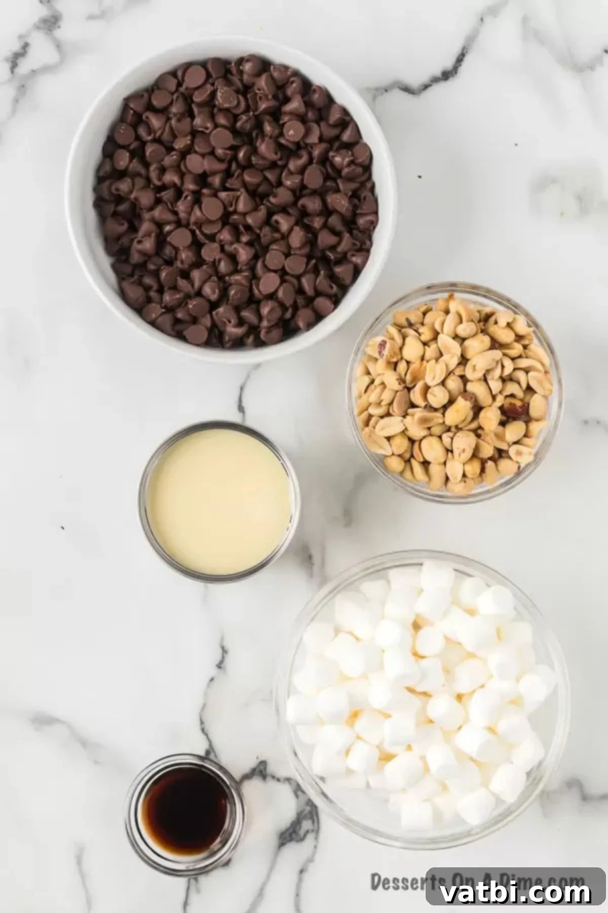 Ingredients for Rocky Road Fudge - semi sweet chocolate chips, sweetened condensed milk, vanilla, marshmallows and peanuts.