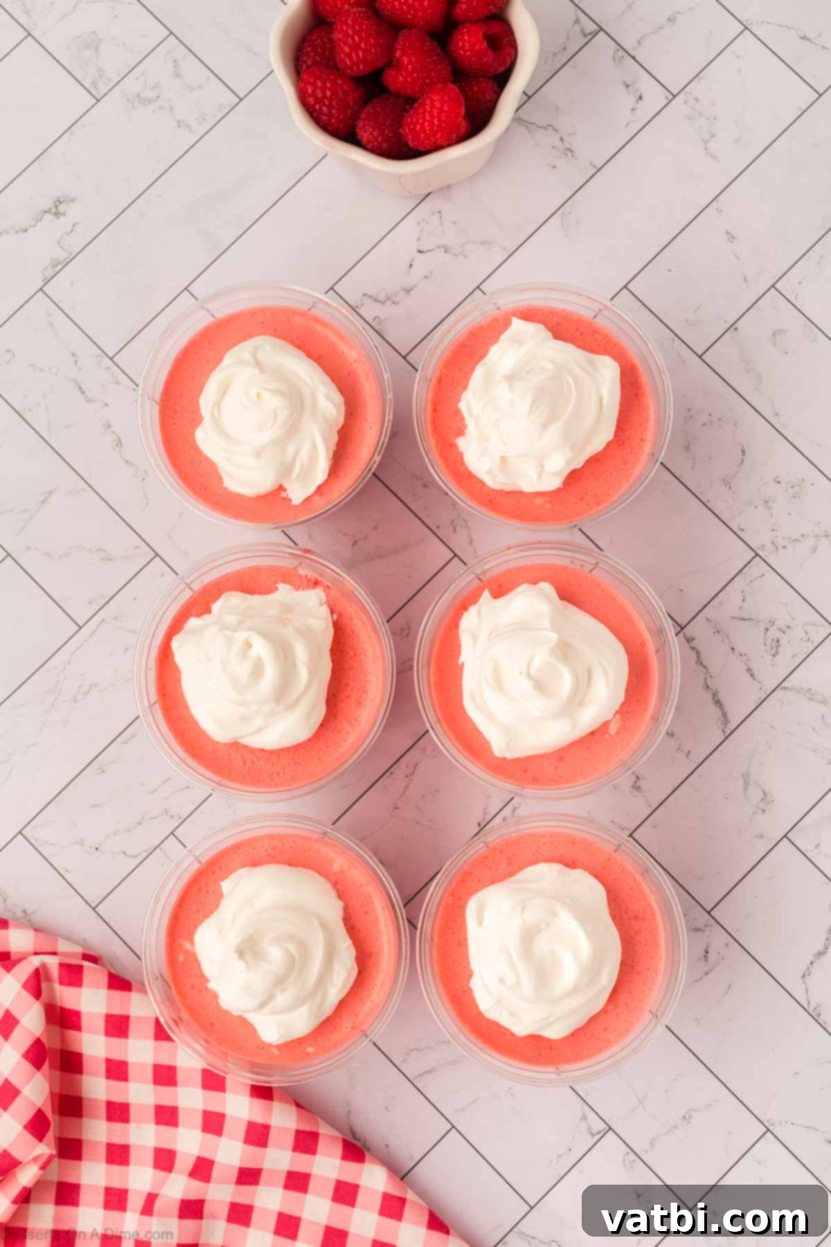 Layered Jello Parfait 11 Whipped cream dolloped and spread on top of each Jello parfait cup.