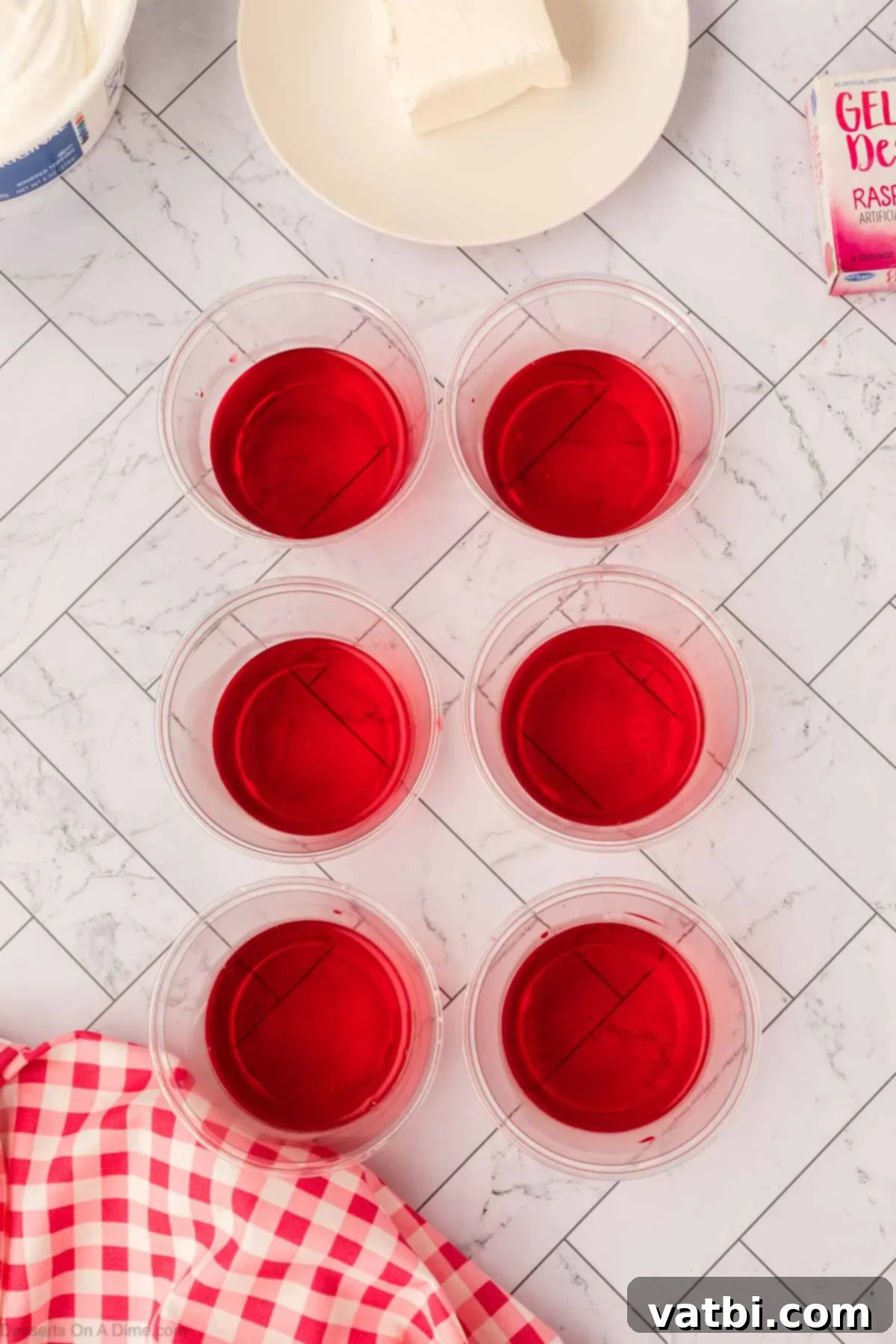 Layered Jello Parfait 5 Prepared Jello liquid divided into six clear dessert cups.
